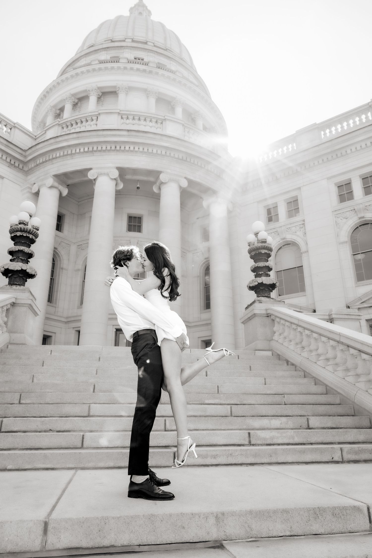 Romantic photoshoot on grand marble steps of a neoclassical government building.