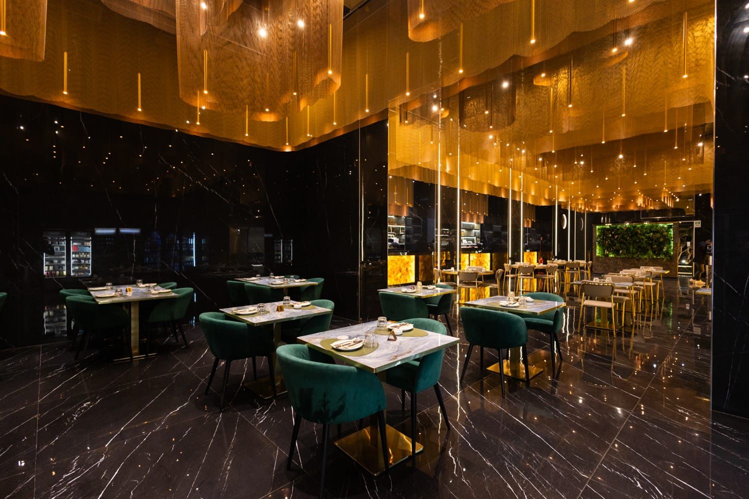 Sala con sedie turchesi e lampade a sospensione, crea un'atmosfera elegante a Trapani, in Sicilia, da Roku Sushi Restaurant.