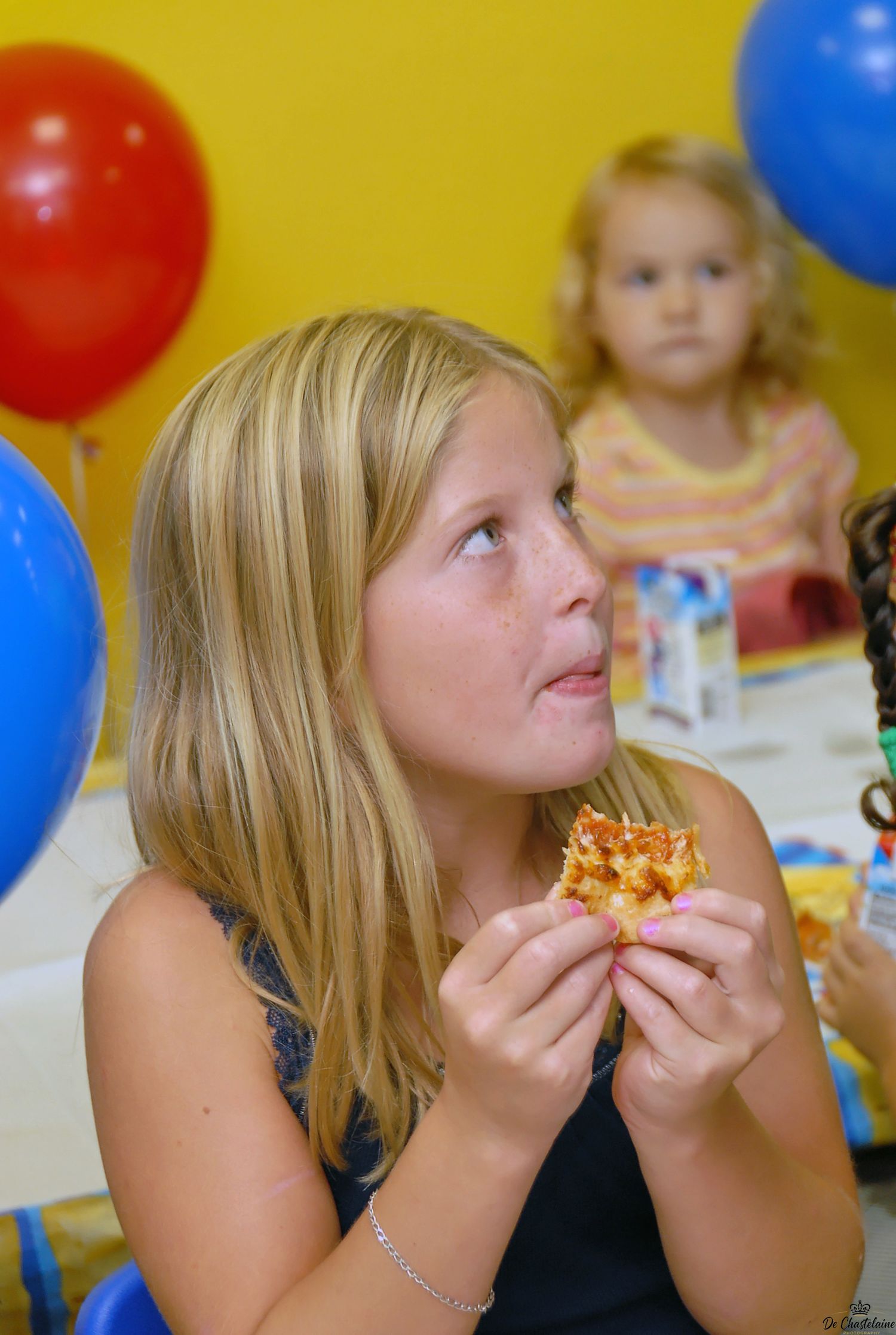 Child portrait girl eating  pizza