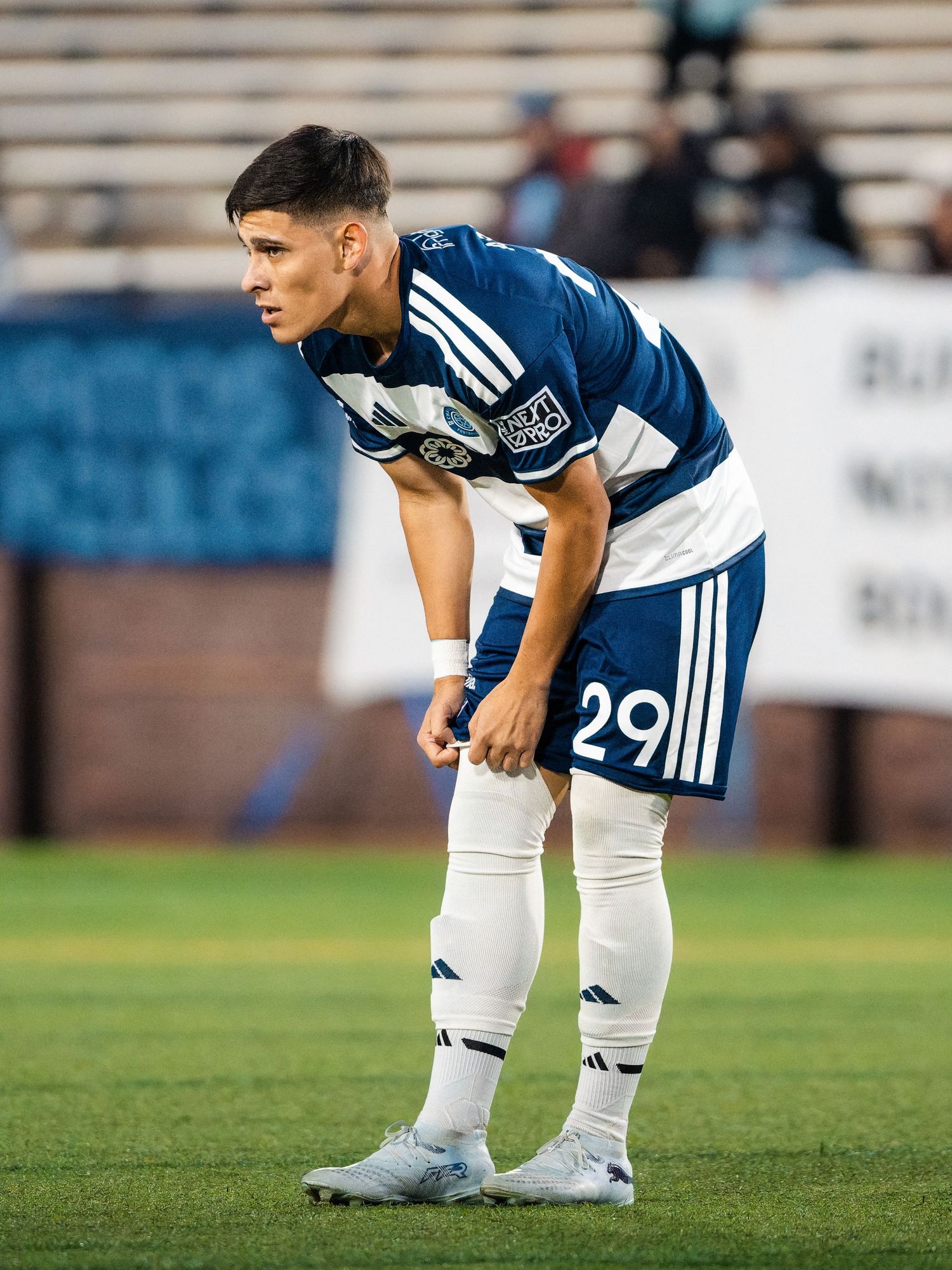 Chattanooga FC Soccer player wearing number 29 in dark blue jersey stands focused during a MLS Next Pro match.