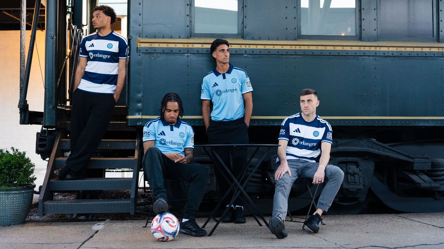 Chattanooga FC players pose in home and away kits near a vintage train photographed for a creative sports assignment in Chattanooga, TN.