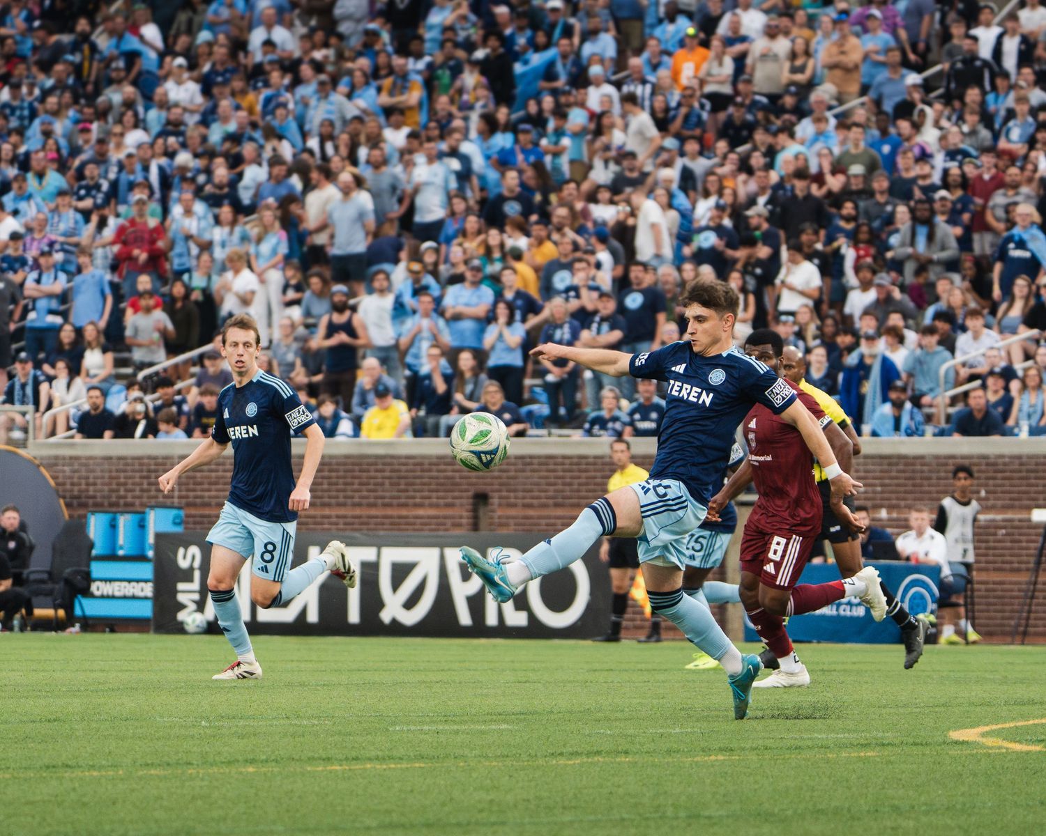 Chattanooga FC Soccer player in light blue Teren kit volleys ball during competitive professional soccer match.