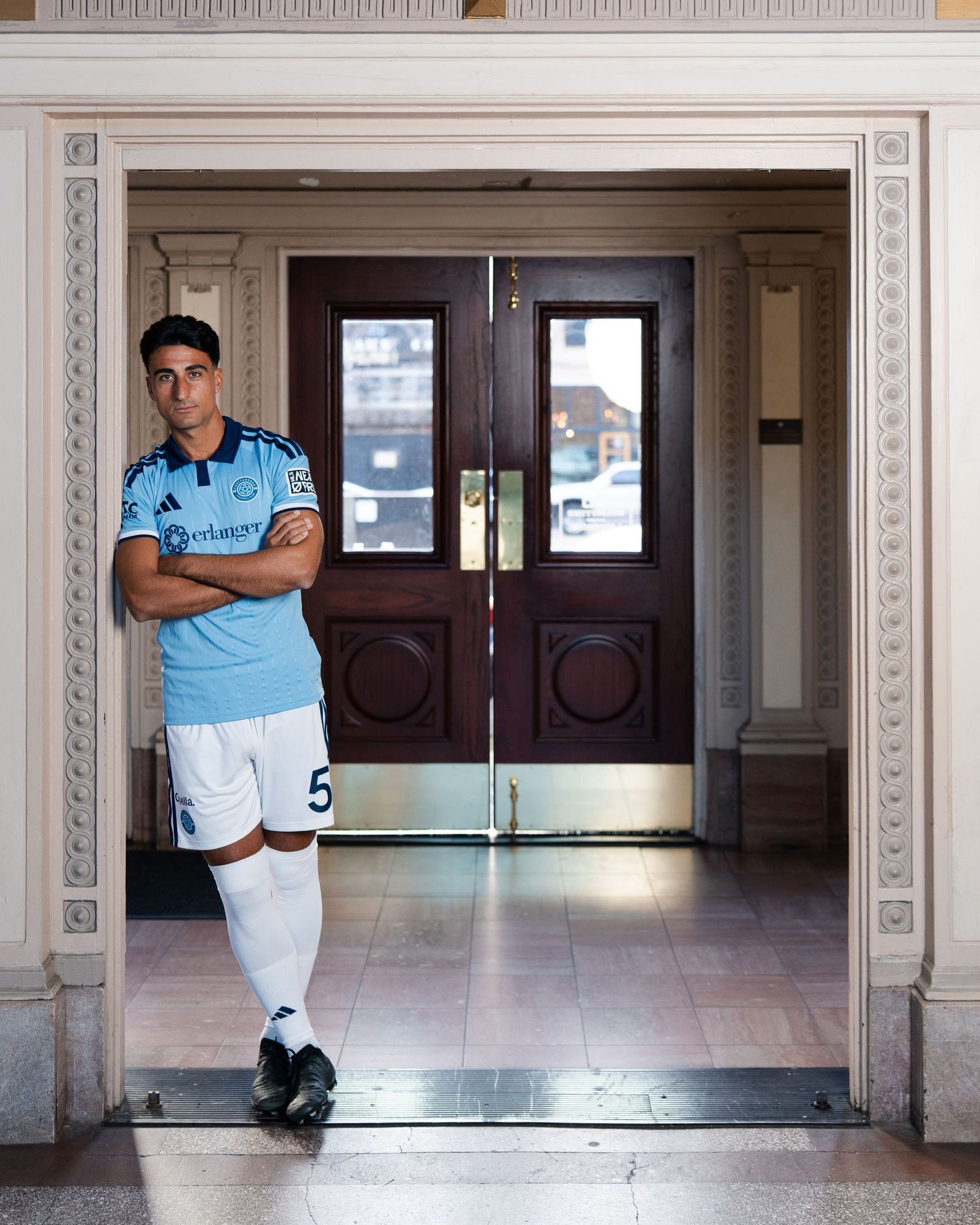 Chattanooga FC player leans in doorway wearing light blue kit photographed for a creative sports assignment in Chattanooga, TN.