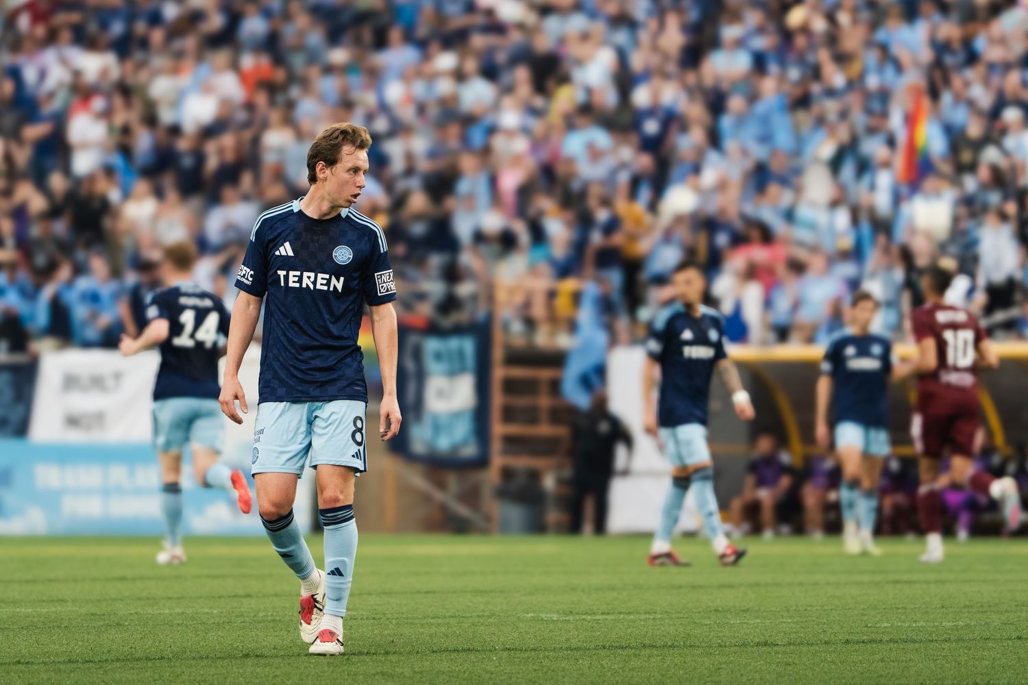Chattanooga FC Soccer player in light blue Teren jersey walks on field during professional match.