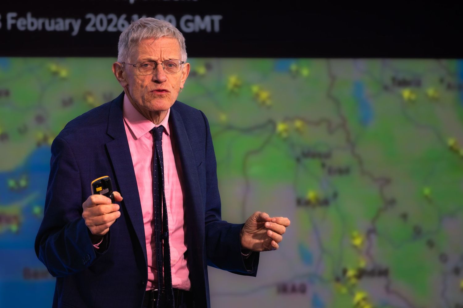 Male speaker presenting on a professional conference on stage.