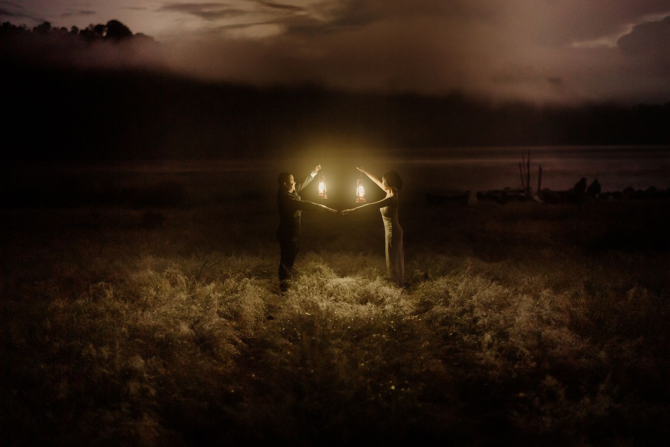 Two glowing antlers illuminate a misty field at night, creating a mystical and ethereal atmosphere.
