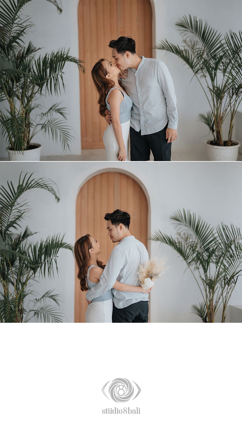 A couple shares a romantic moment in a bright studio with tropical plants and an arched wooden backdrop, captured by Studio 8 Bali.