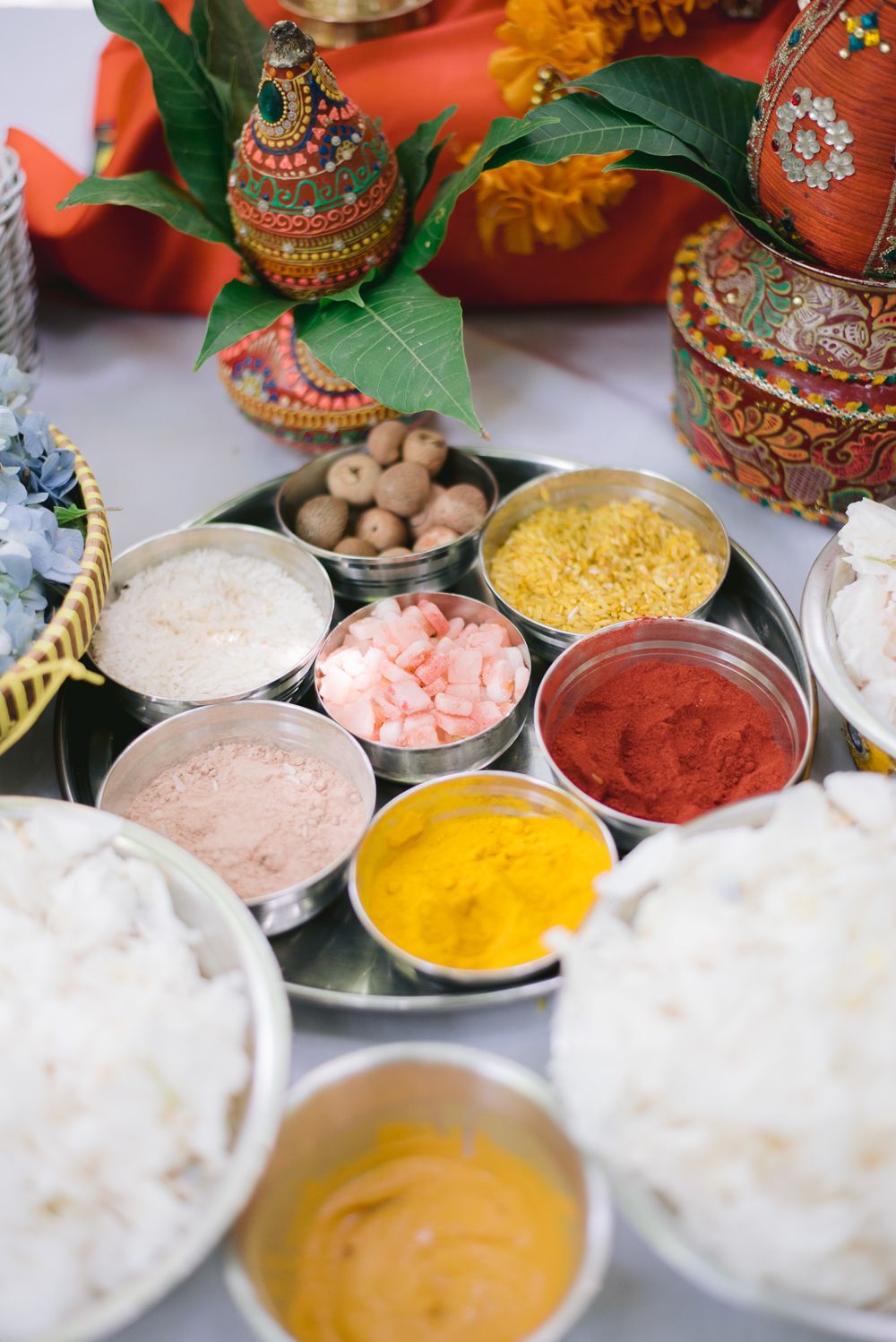 Traditional Indian puja thali with turmeric, vermillion, rice, and sacred offerings arranged for a Hindu religious ceremony.