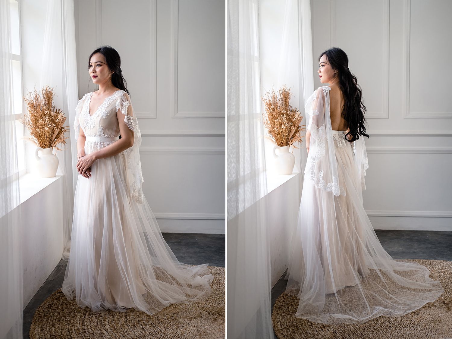 Elegant bride in a flowing white tulle V-neck wedding gown with flutter sleeves and a long train, posed by a window.