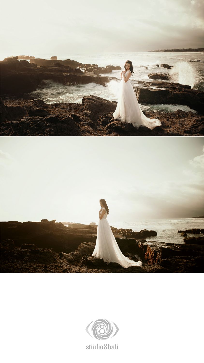 Bride in flowing white gown poses on rocky coastal cliffs with ocean waves crashing behind her at sunset.