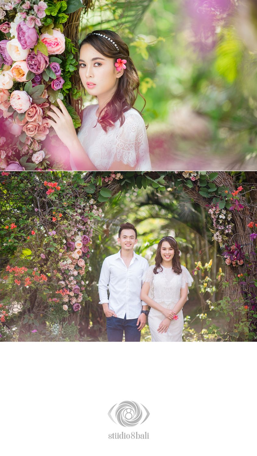 Couple poses under floral arch in garden, woman with pink flower in hair holds blooms in romantic pre-wedding photo shoot.