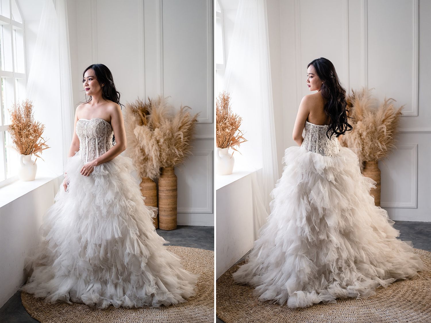 Bride in strapless feathered wedding gown with beaded bodice poses near window with pampas grass decor.