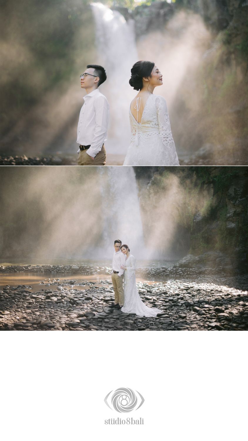 Couple in wedding attire poses before a misty waterfall on rocky terrain, with light rays illuminating their romantic shoot.