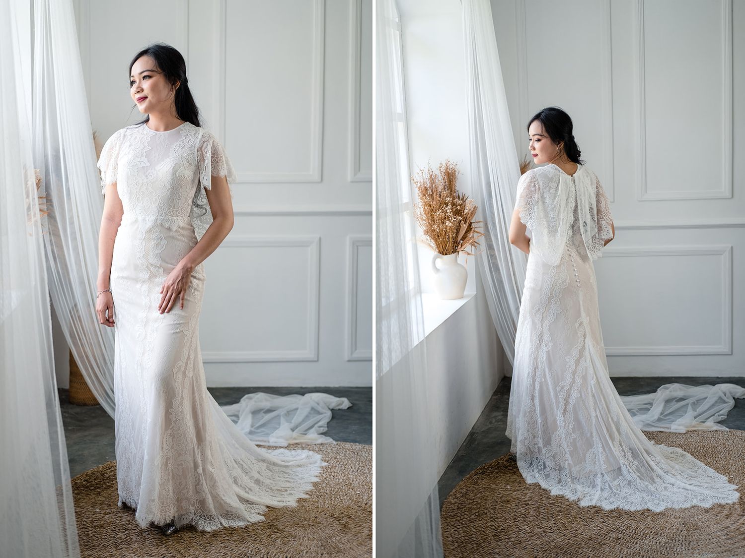 Bride wearing a fitted white lace mermaid wedding dress with short sleeves and a chapel train, standing by a window.