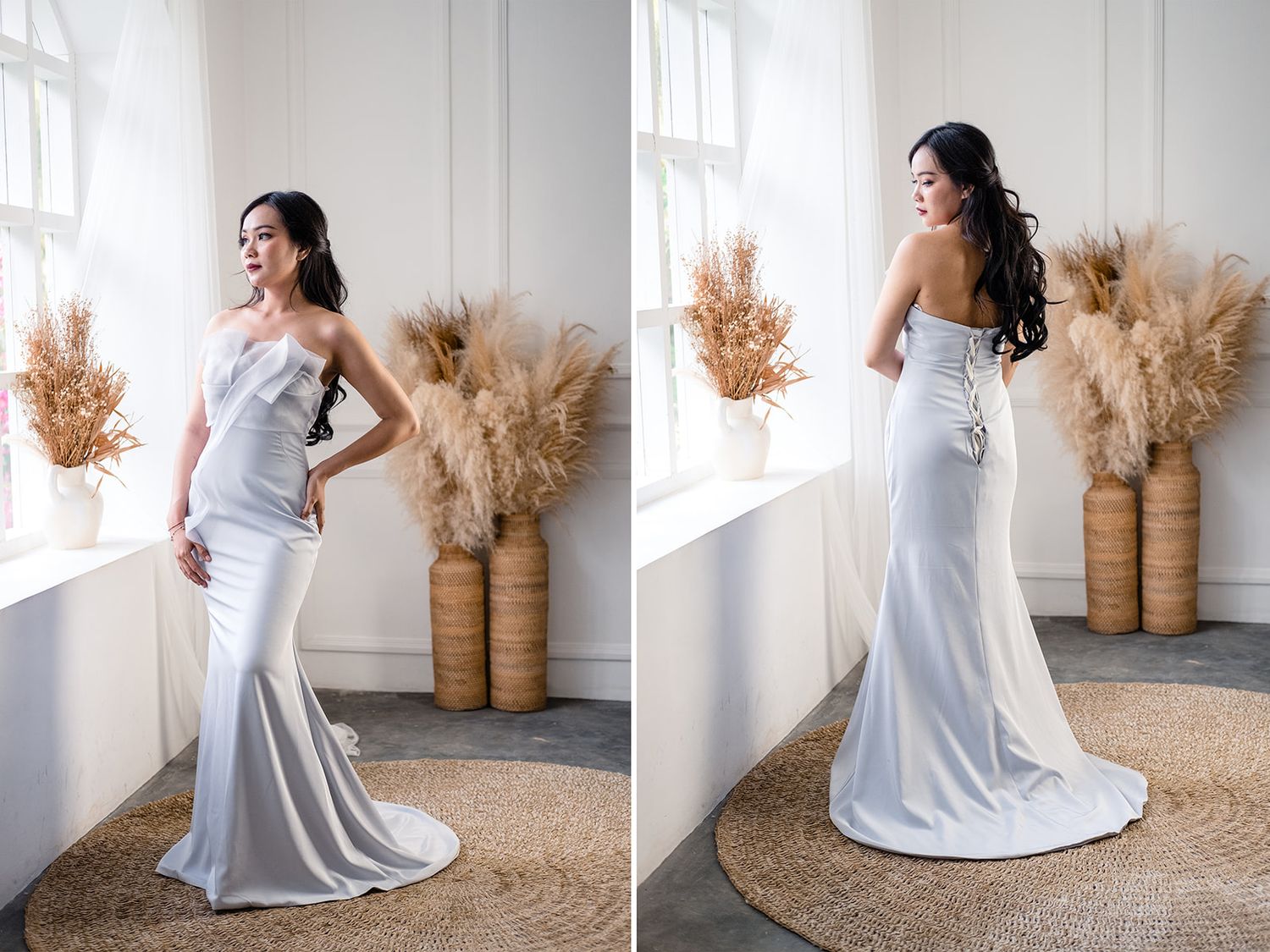 Elegant woman in a white strapless mermaid wedding gown posed near a bright window with pampas grass decor.