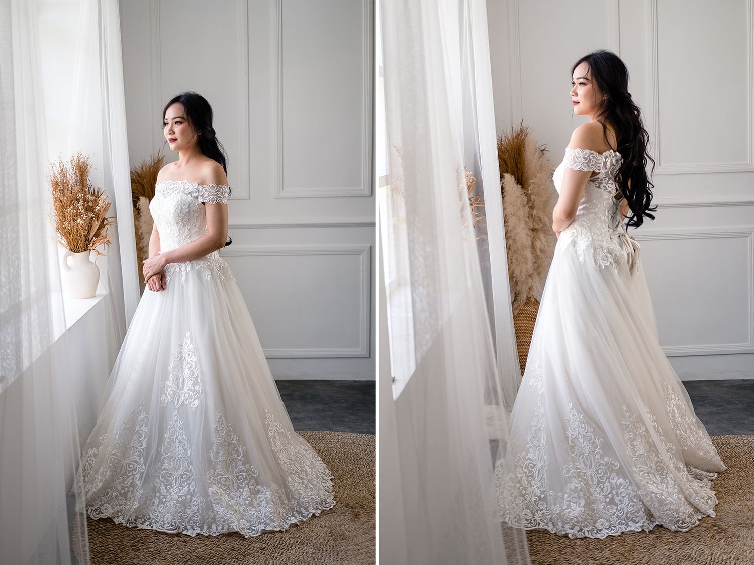 Elegant bride in off-shoulder lace A-line wedding gown with floral embroidery, posing near a window in soft natural light.