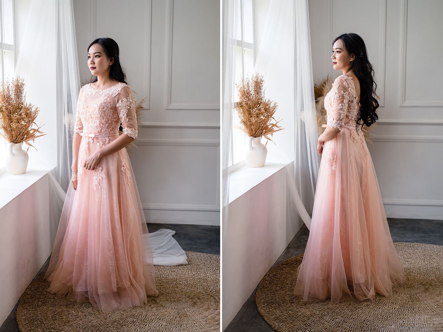 Woman in elegant blush pink lace tulle floor-length gown posing by a bright window with dried floral arrangements.