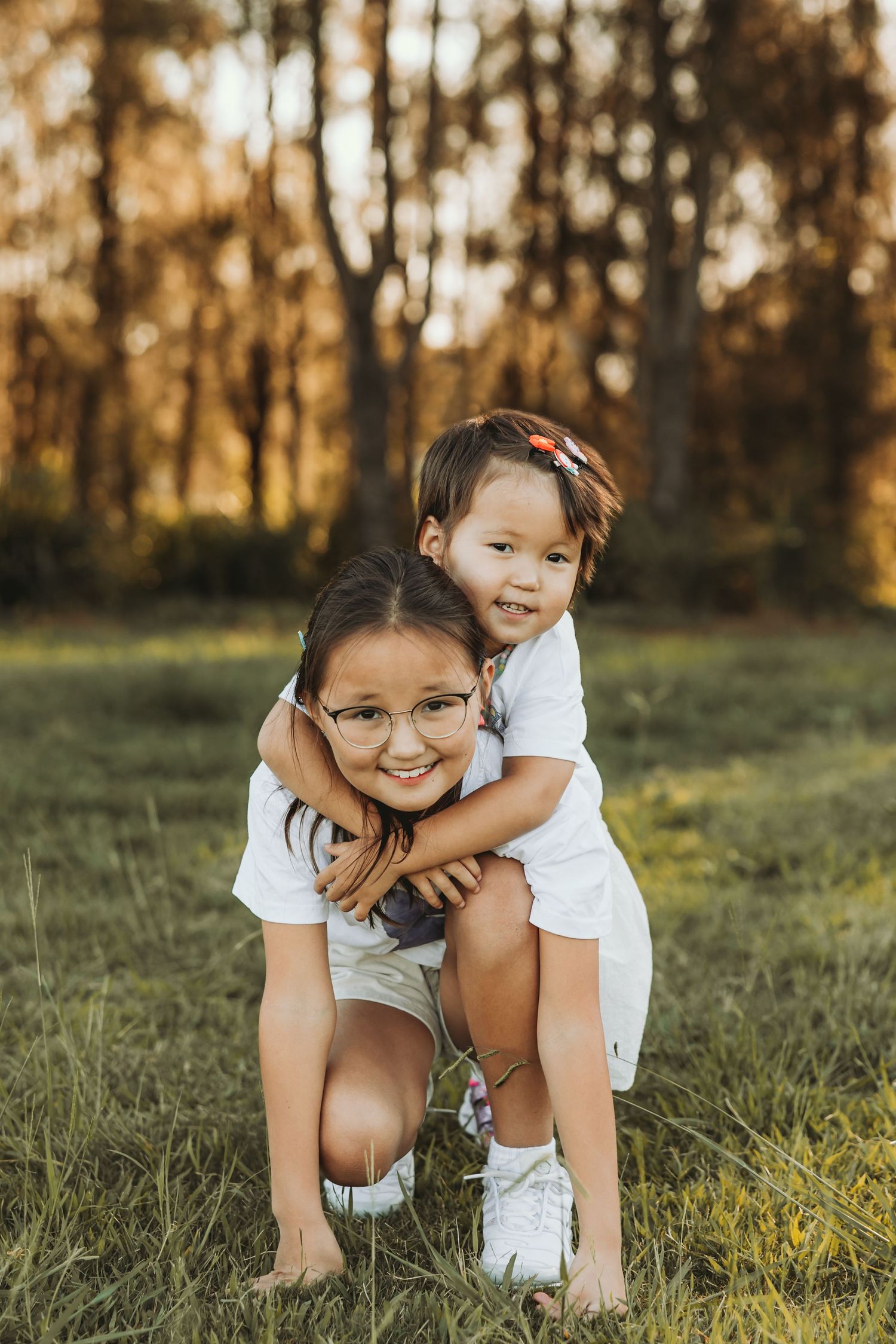Children hugging outdoors in golden hour light, Sydney family photography