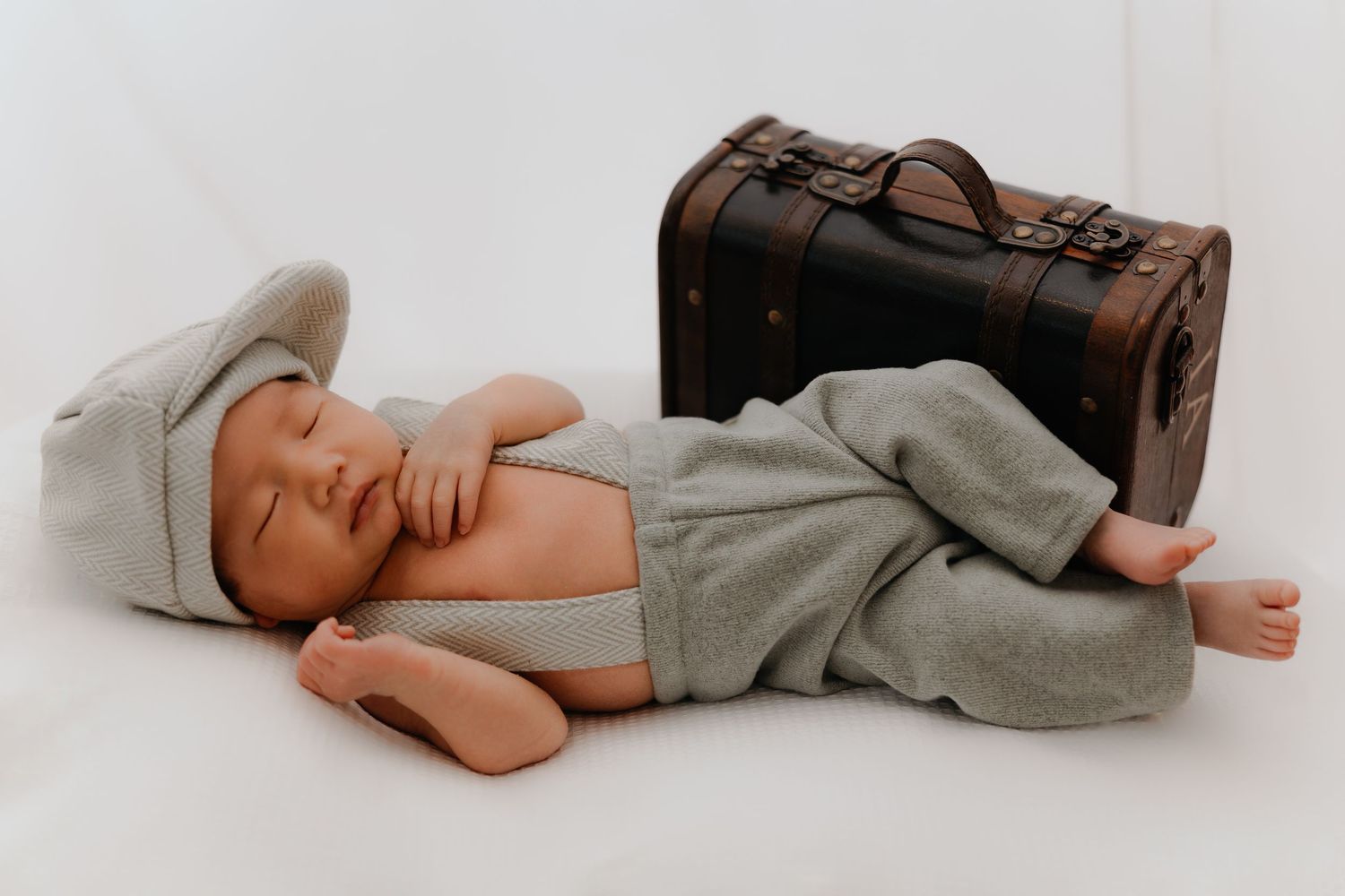 Newborn baby lying on a soft blanket with props, Sydney newborn photography