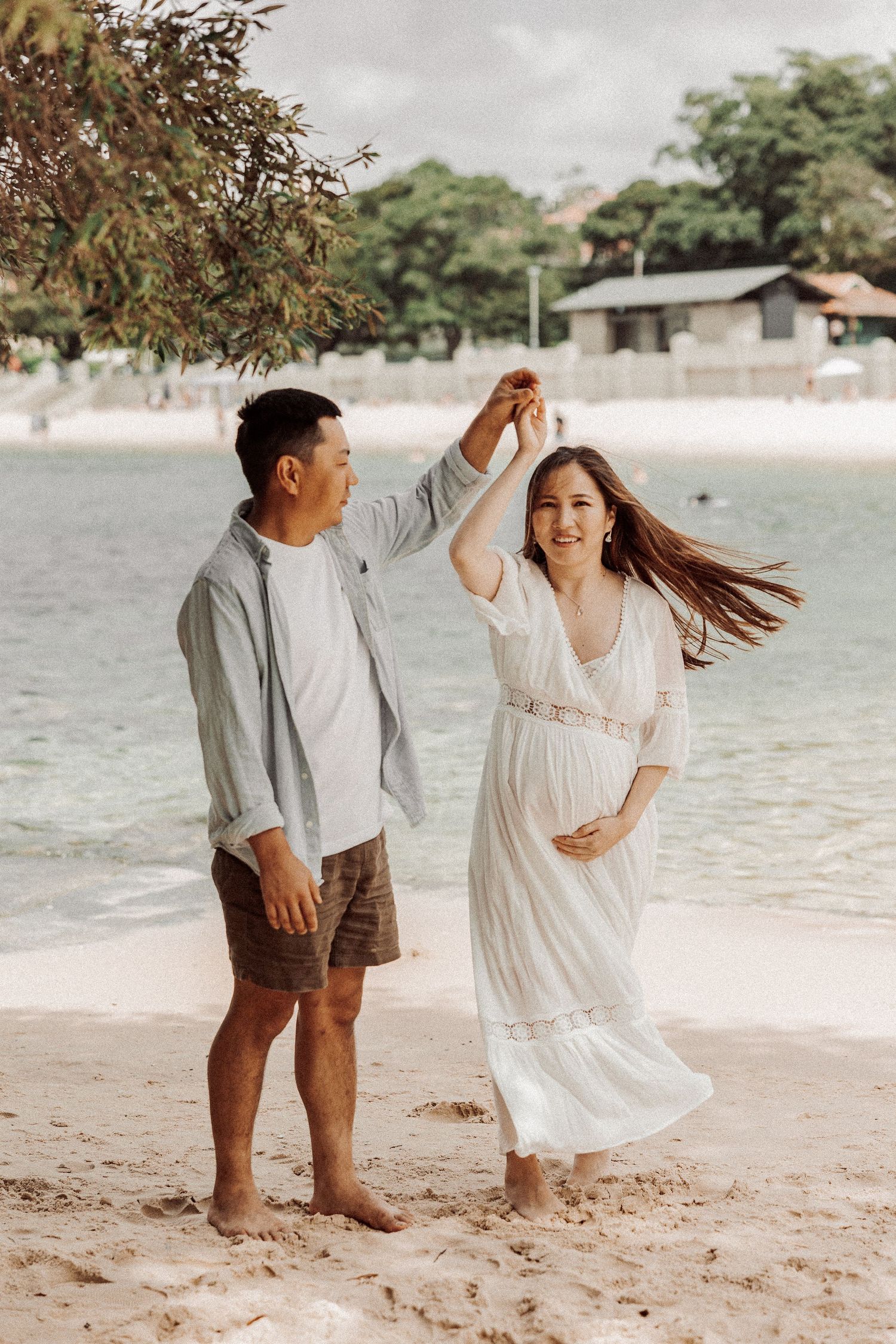 Couple maternity portrait walking on beach in soft light, Sydney maternity photographer