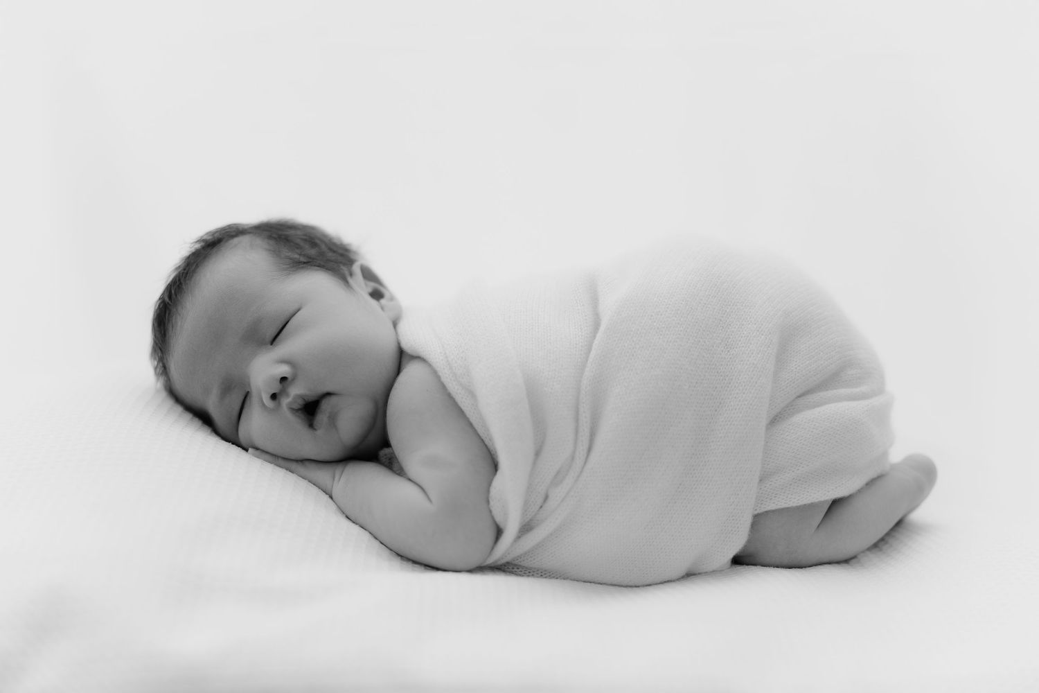 Black and white newborn portrait wrapped in blanket, Sydney newborn photographer