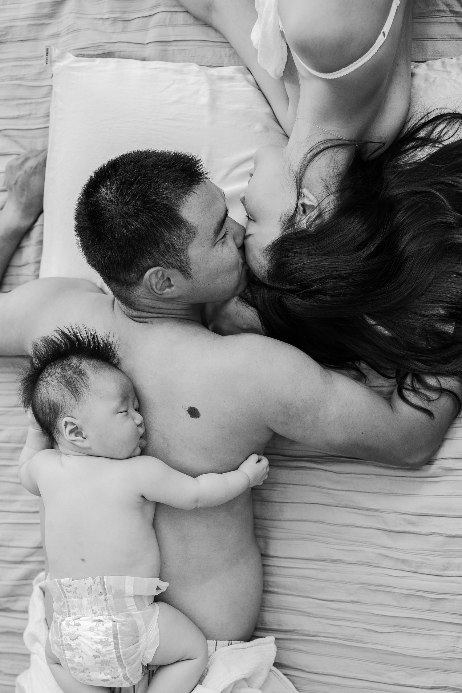 Black and white lifestyle photo of a mother with newborn and toddler, at home session Sydney