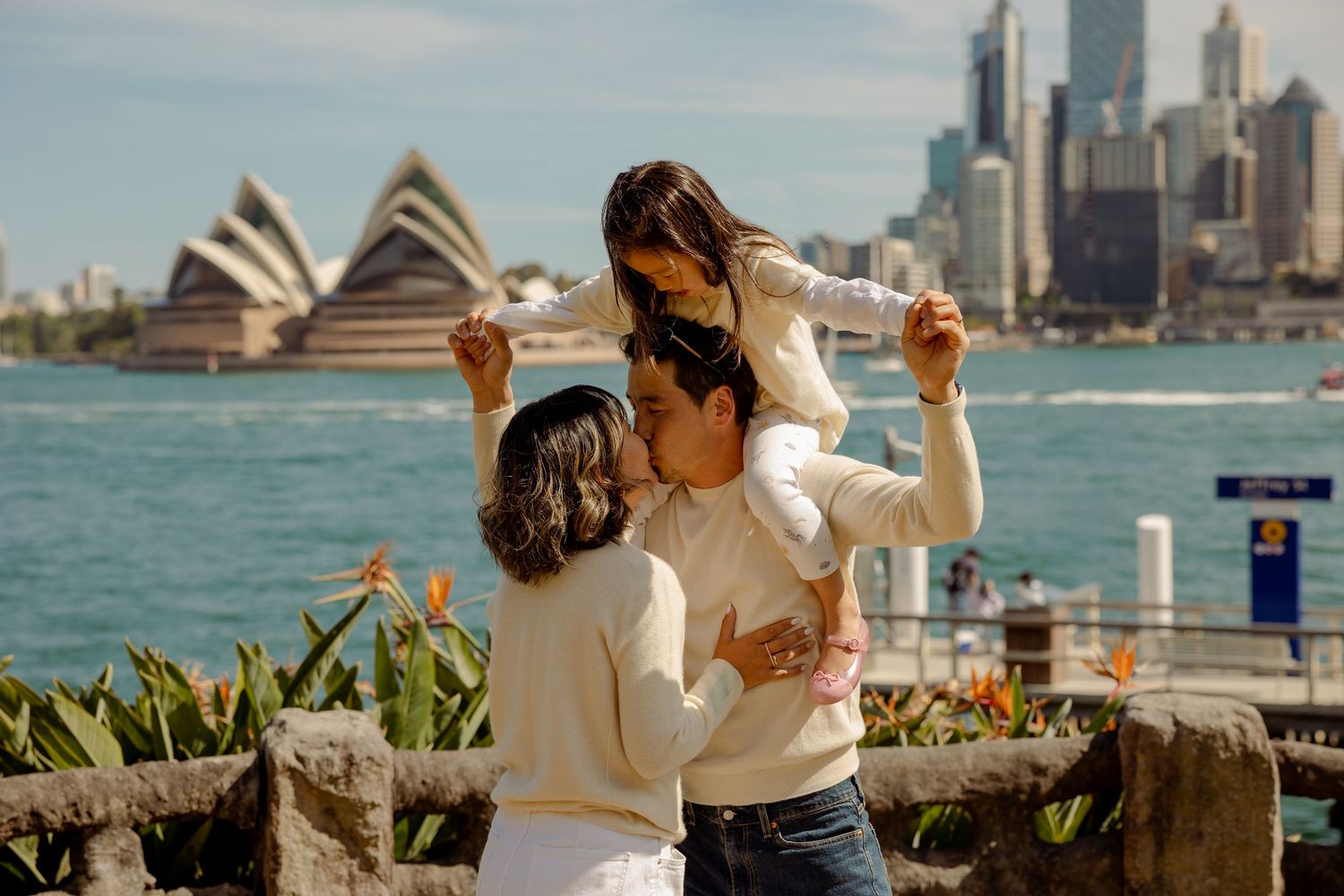 Couple with baby at Sydney Harbour with Opera House in background, Sydney family photographer