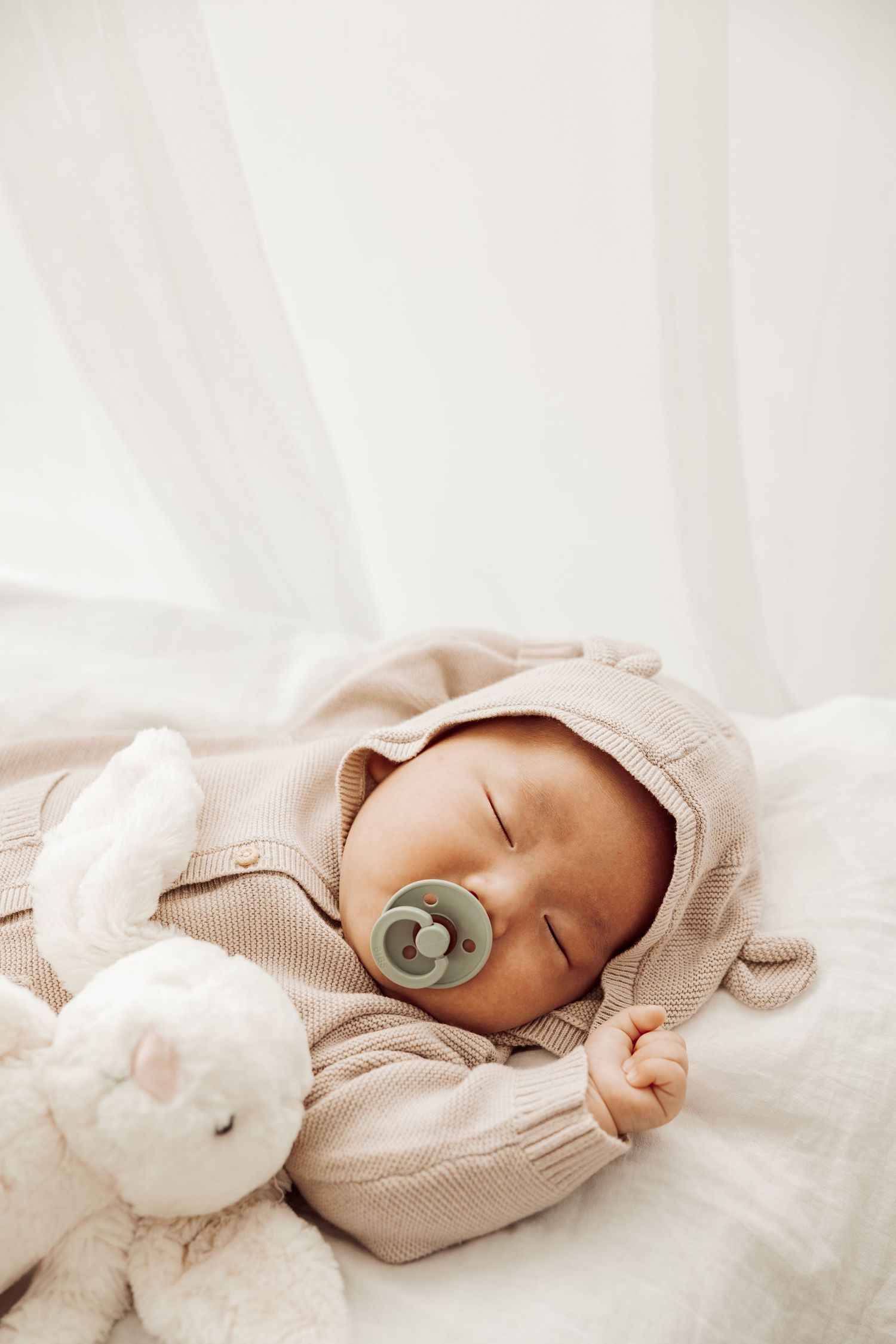 Newborn baby sleeping with pacifier in soft natural light, Sydney newborn photographer