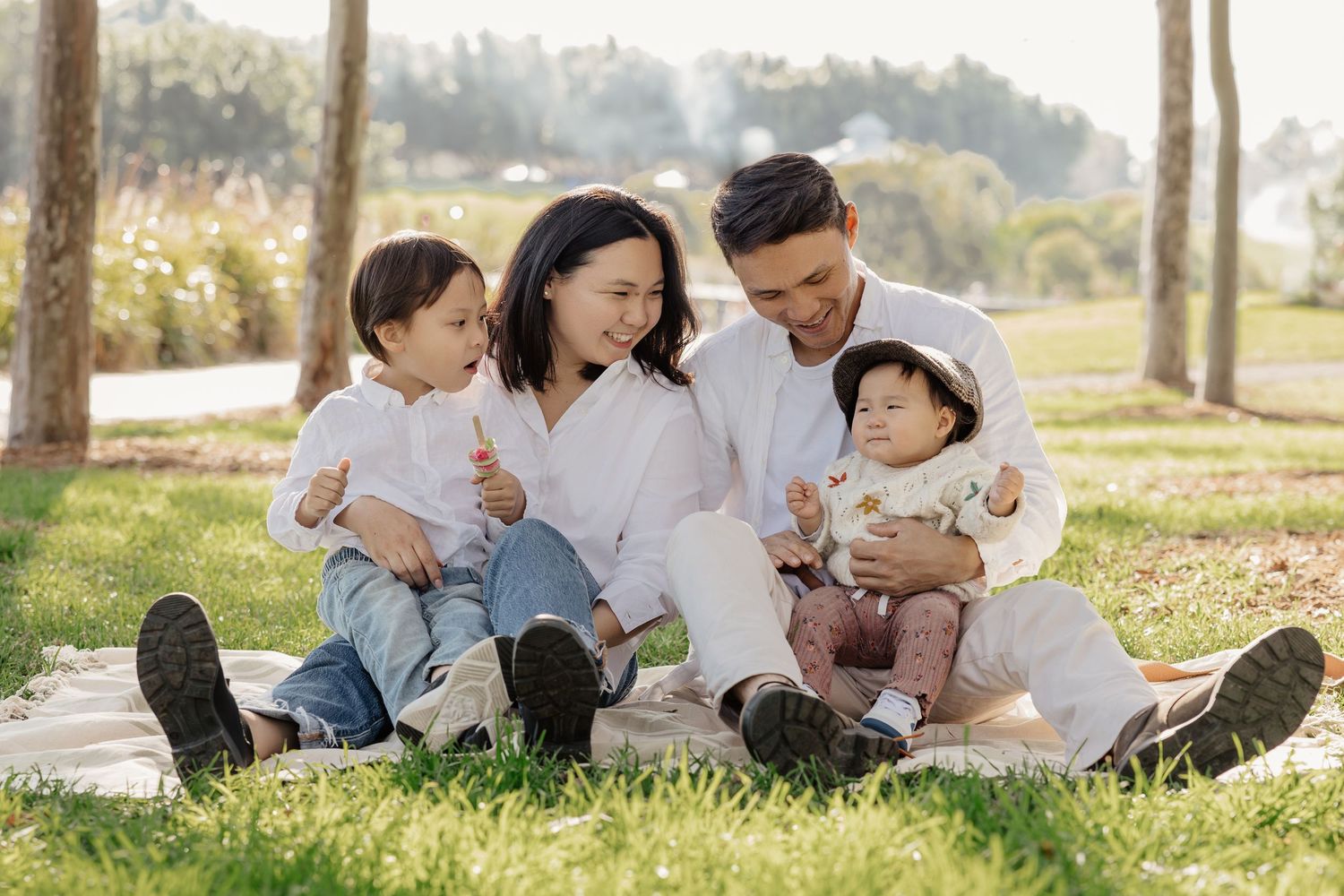 Outdoor family portrait sitting on grass in natural light, Sydney family photography