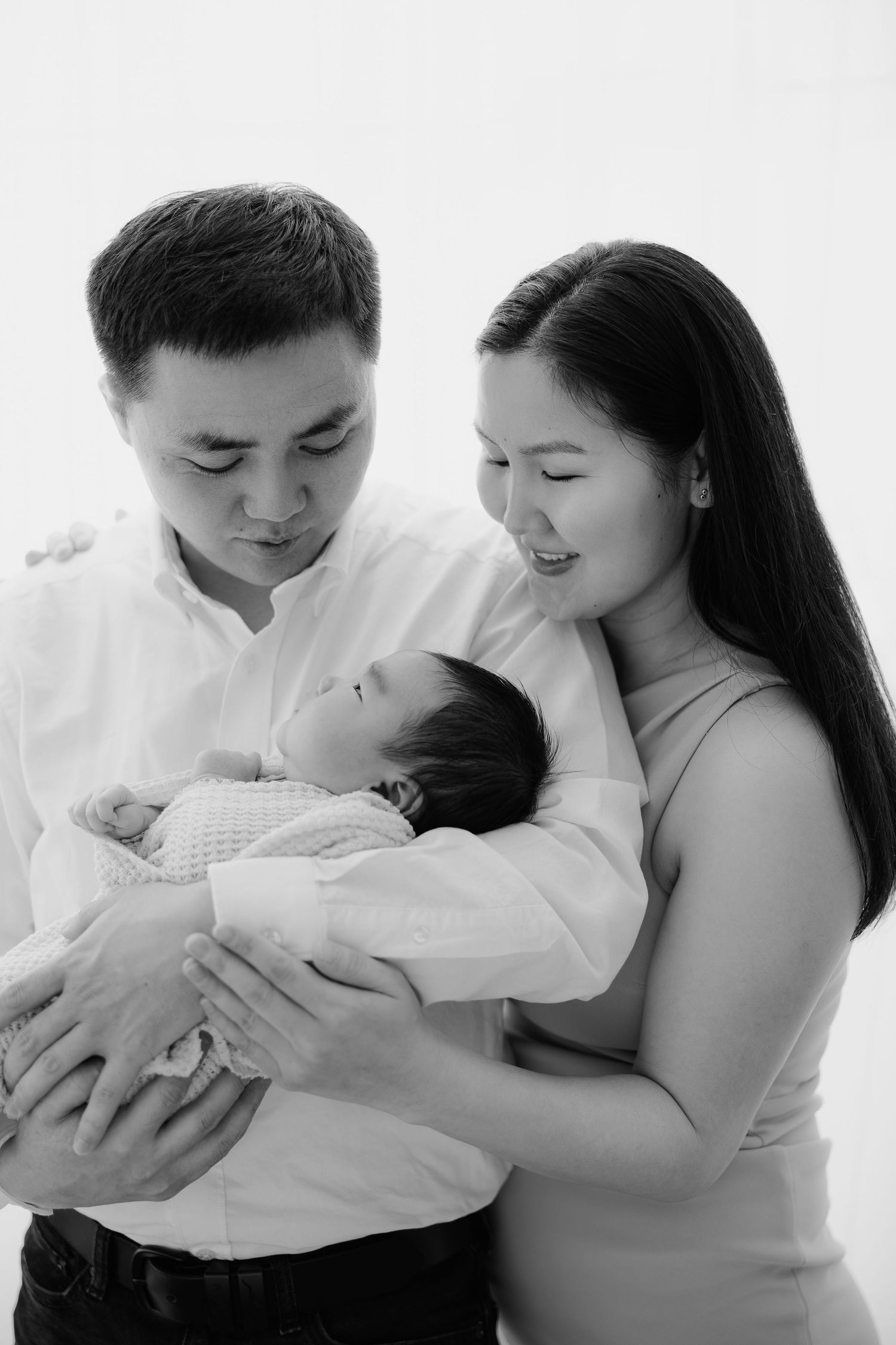 Black and white newborn family portrait holding baby, Sydney newborn photography