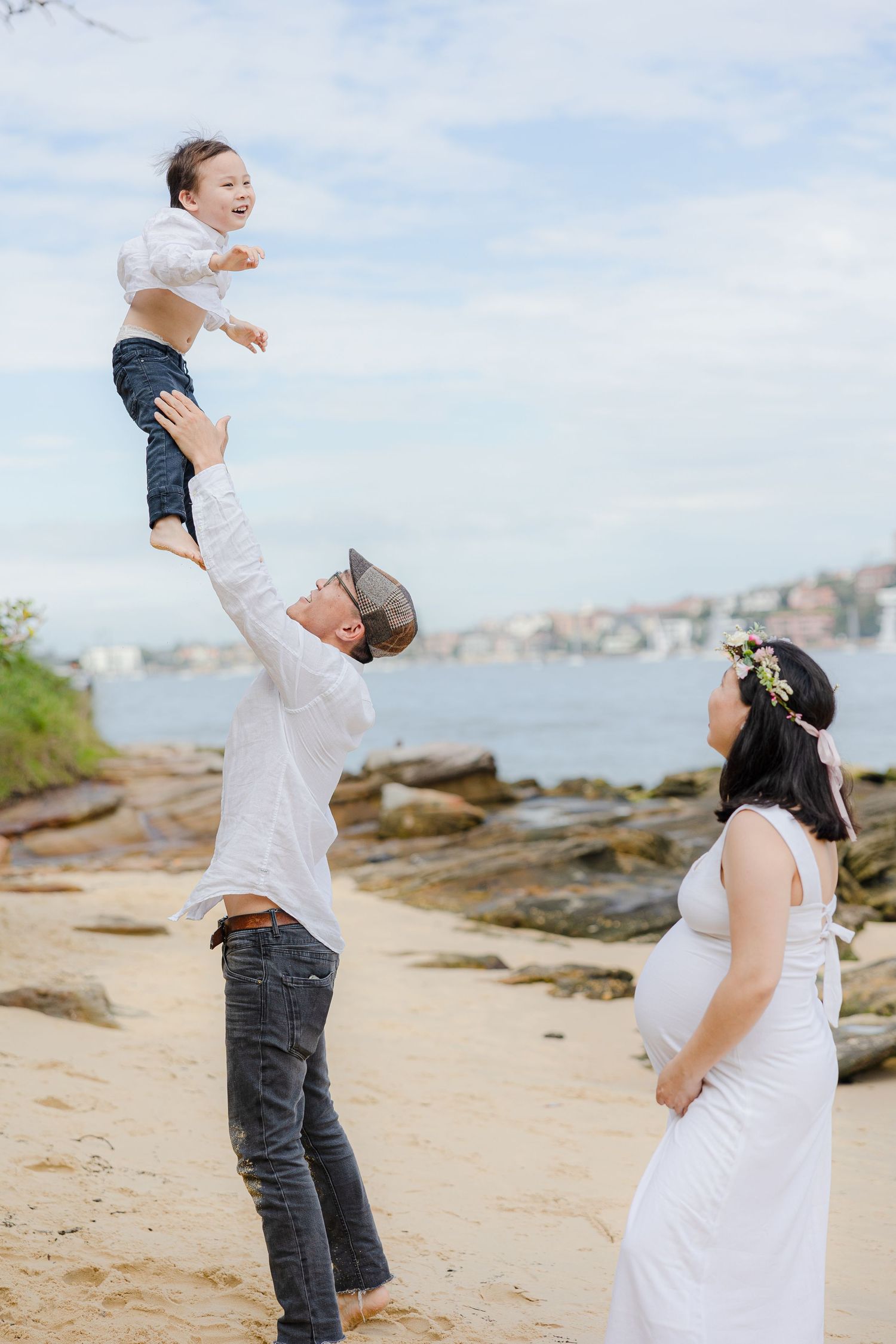 Family playful portrait lifting child at beach, Sydney family photography