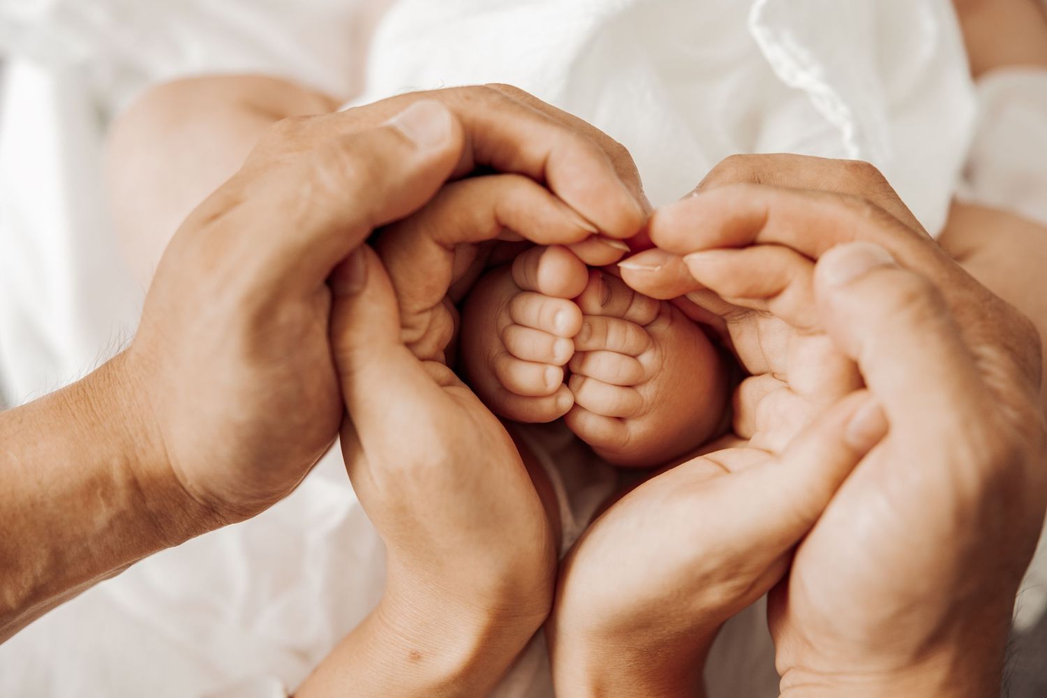 Close-up of parents holding newborn baby feet, lifestyle newborn photography Sydney