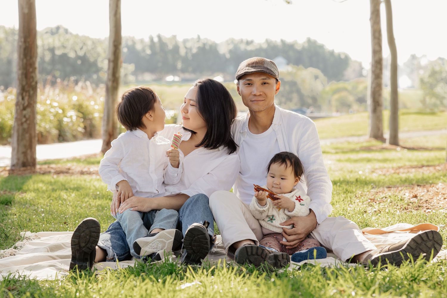 Family sitting on a picnic blanket outdoors, Sydney family photography session