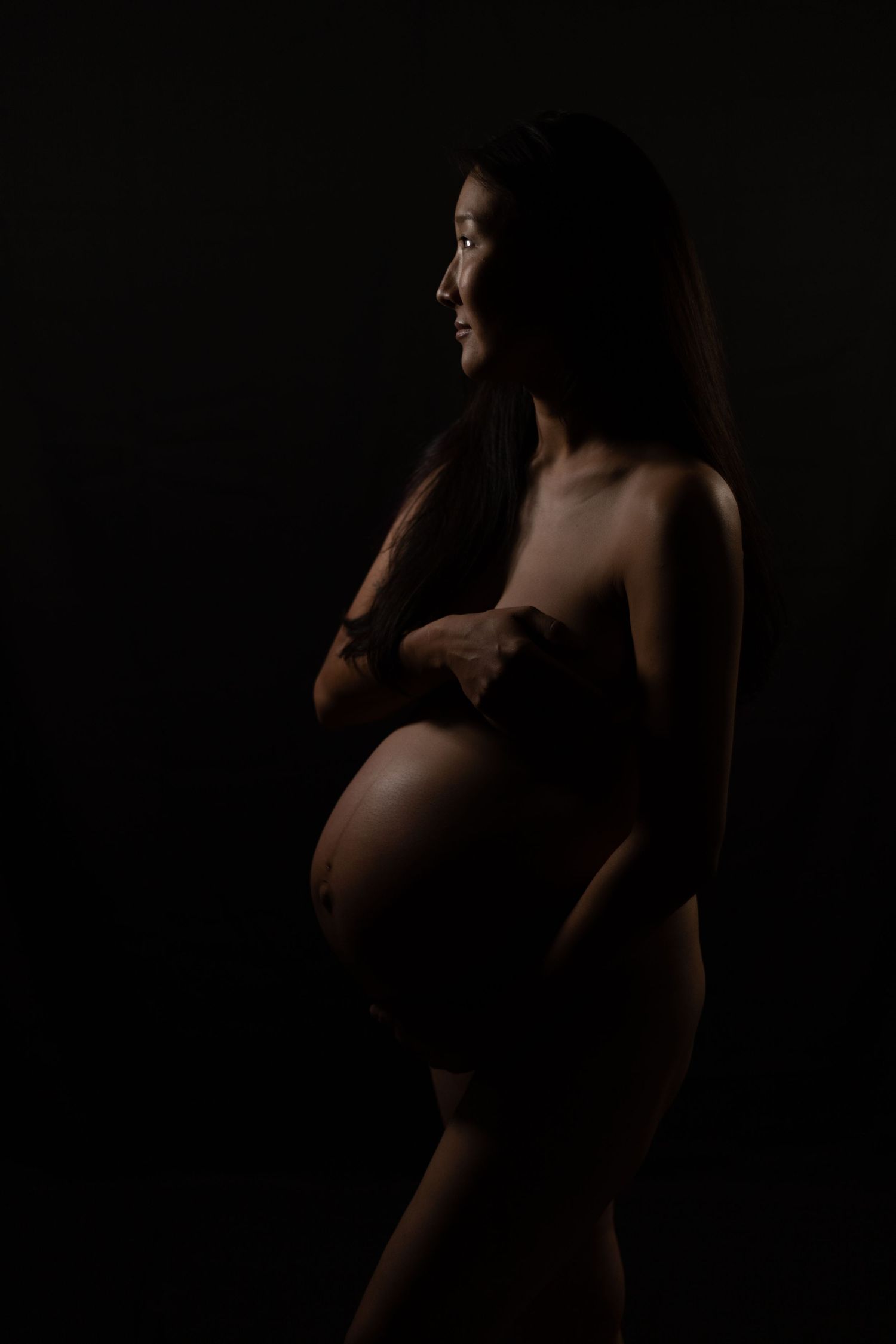 Studio maternity portrait in Sydney with dramatic low key lighting
