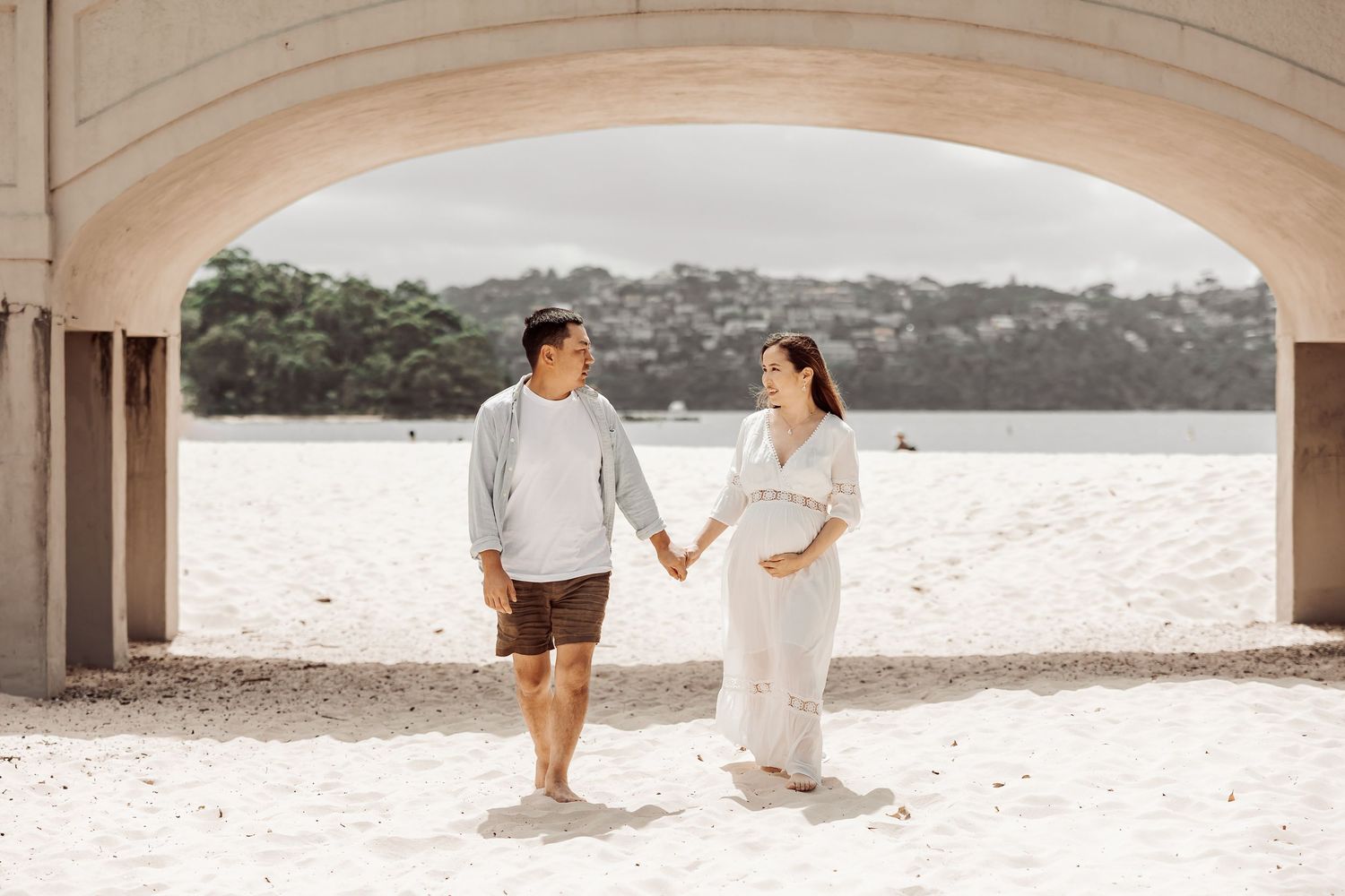 Couple maternity portrait under archway by water, Sydney maternity photographer