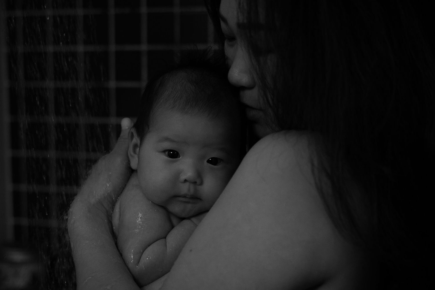 Black and white lifestyle newborn photo of a mother holding her baby, Sydney newborn photographer