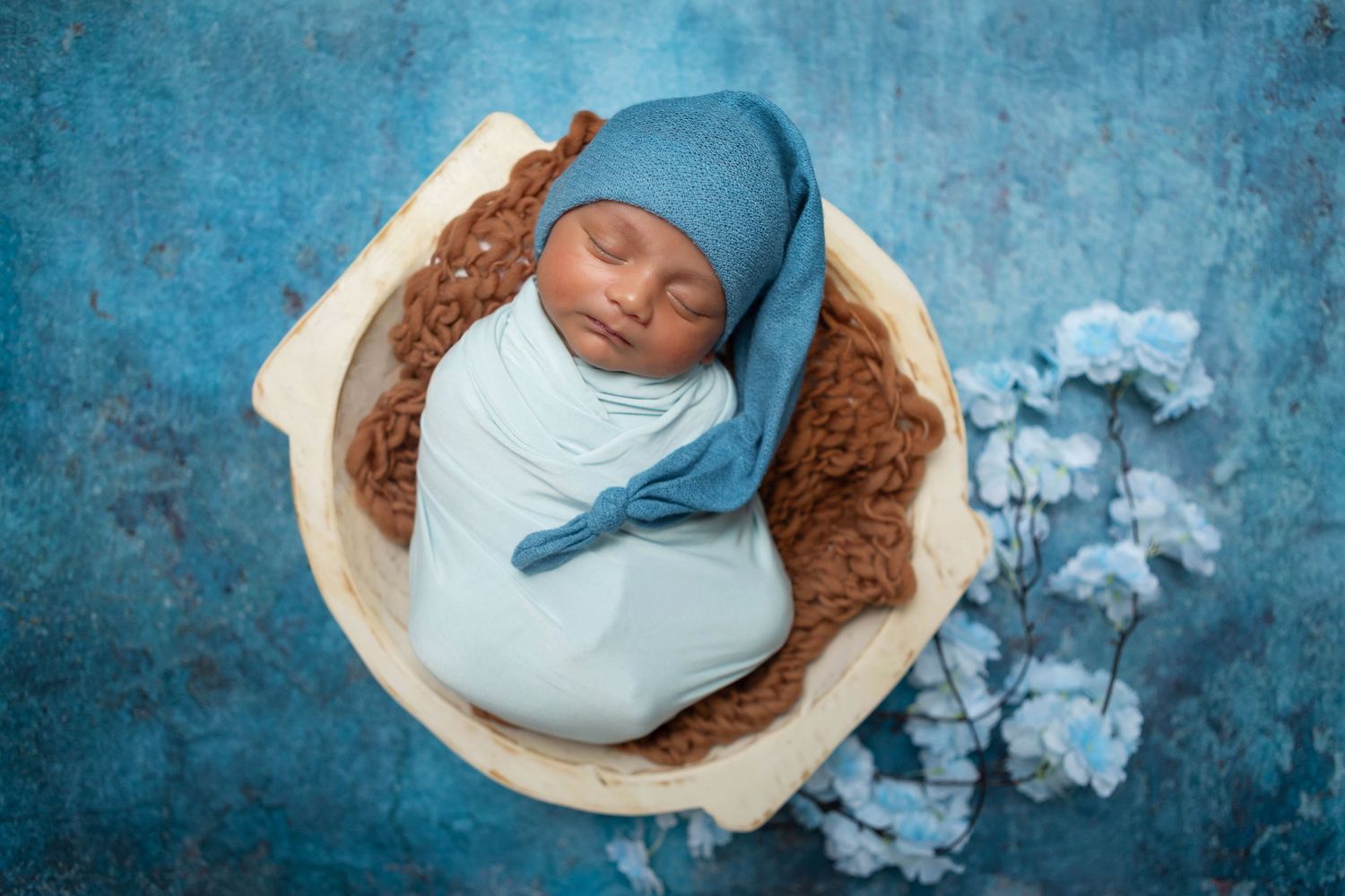 baby boy posed in white round bowl