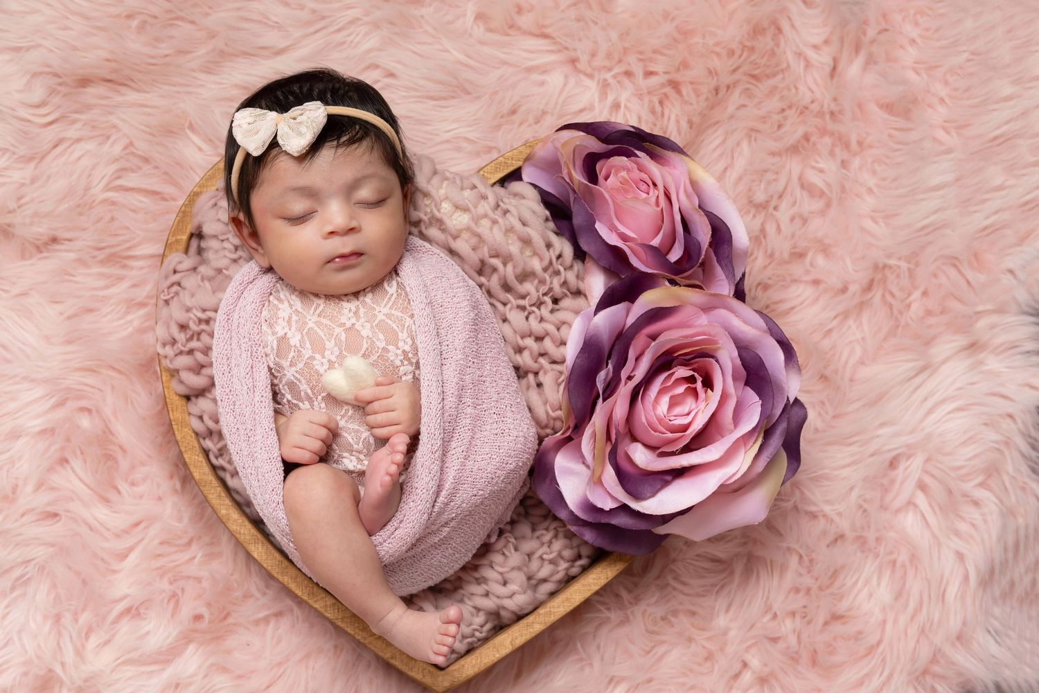 Newborn baby beautifully styled in studio props