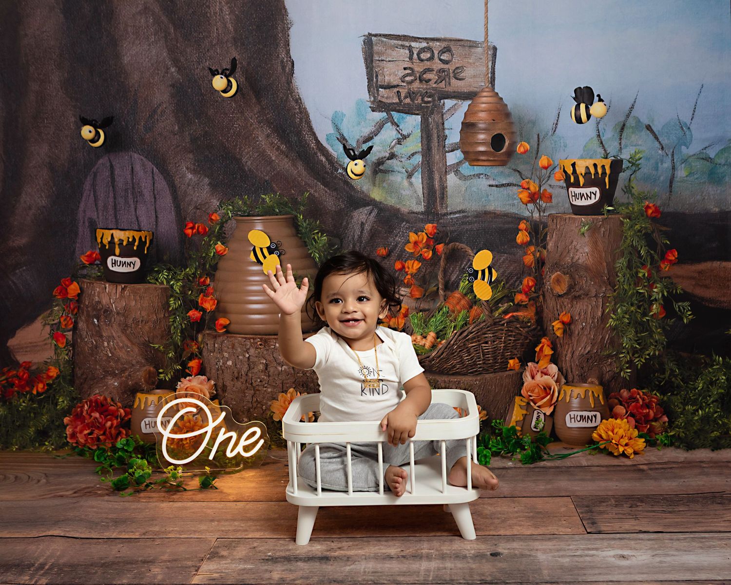 Pooh bear first birthday. Baby boy in small white crib waving