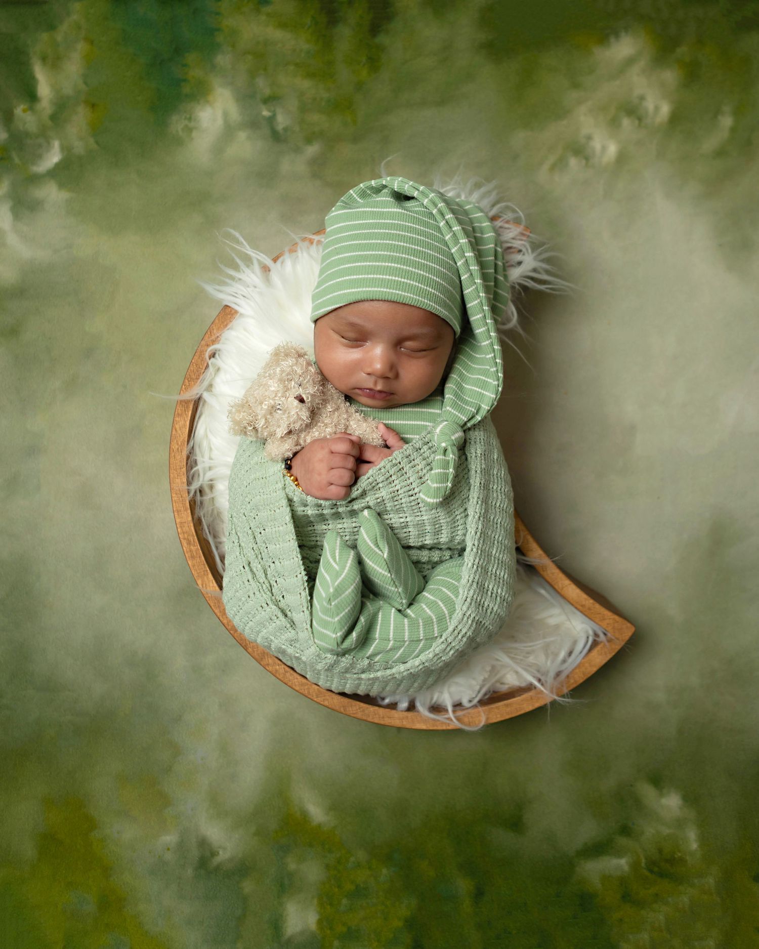 Newborn baby beautifully styled in studio props