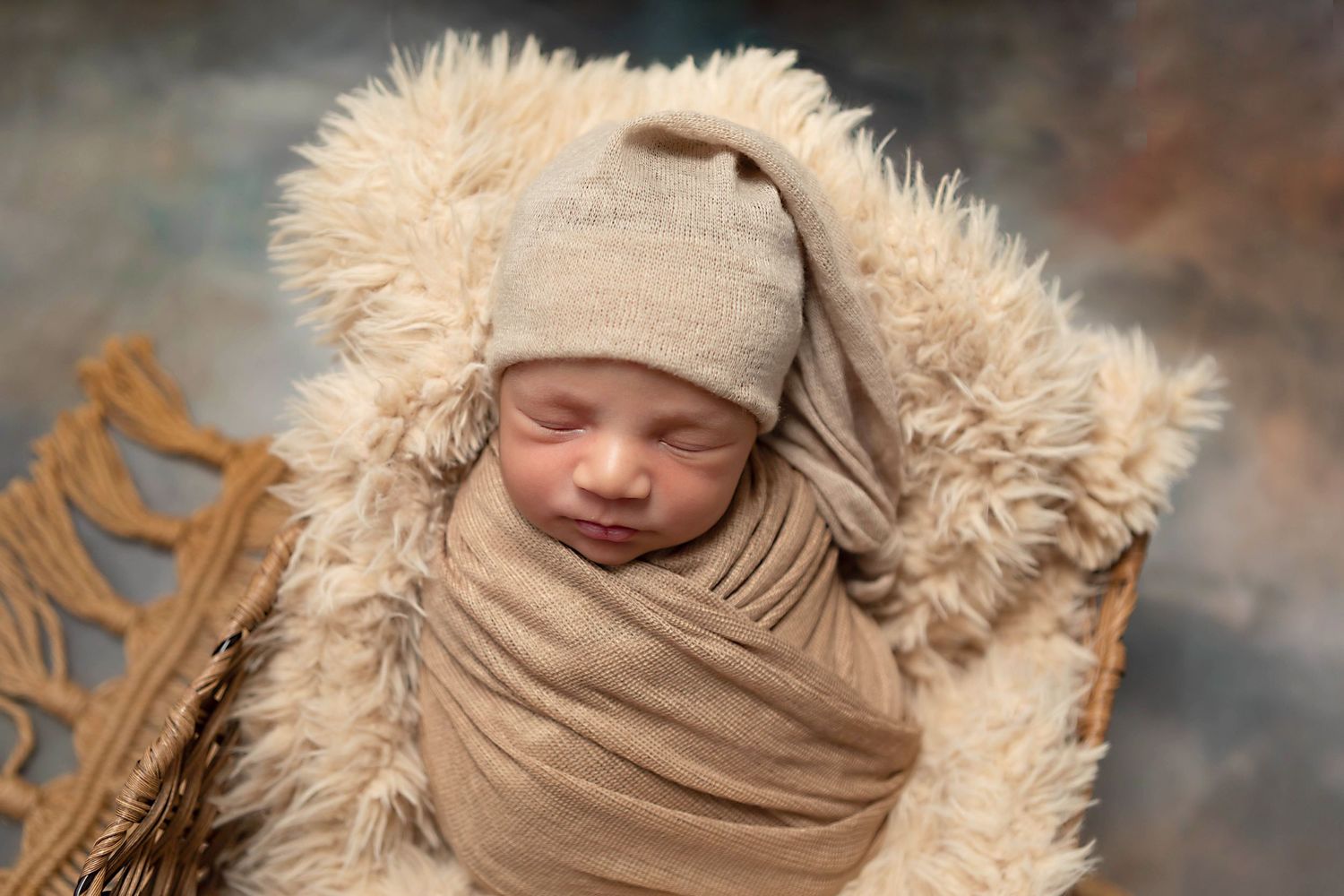 Newborn baby beautifully styled in studio props