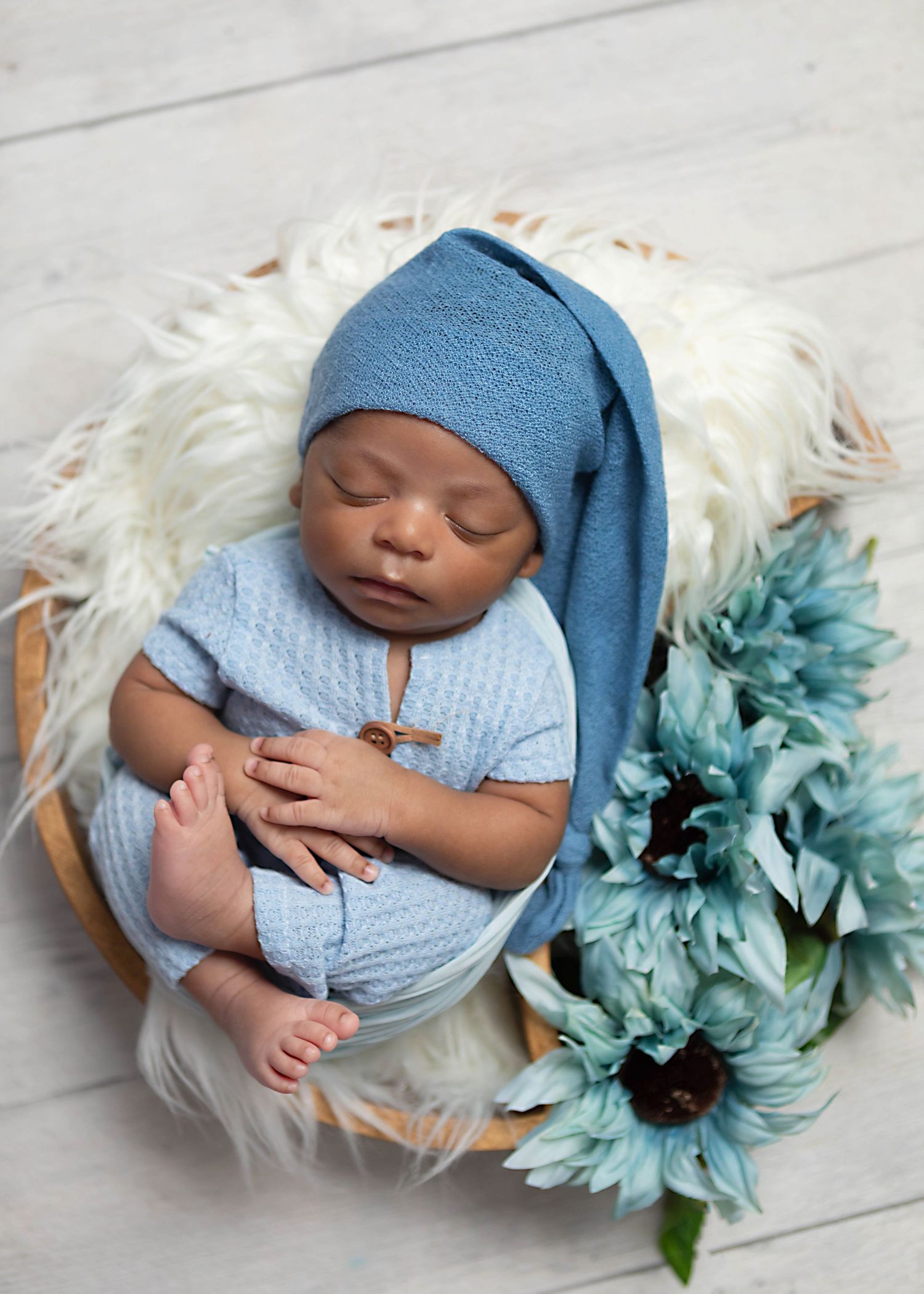 Newborn baby beautifully styled in studio props