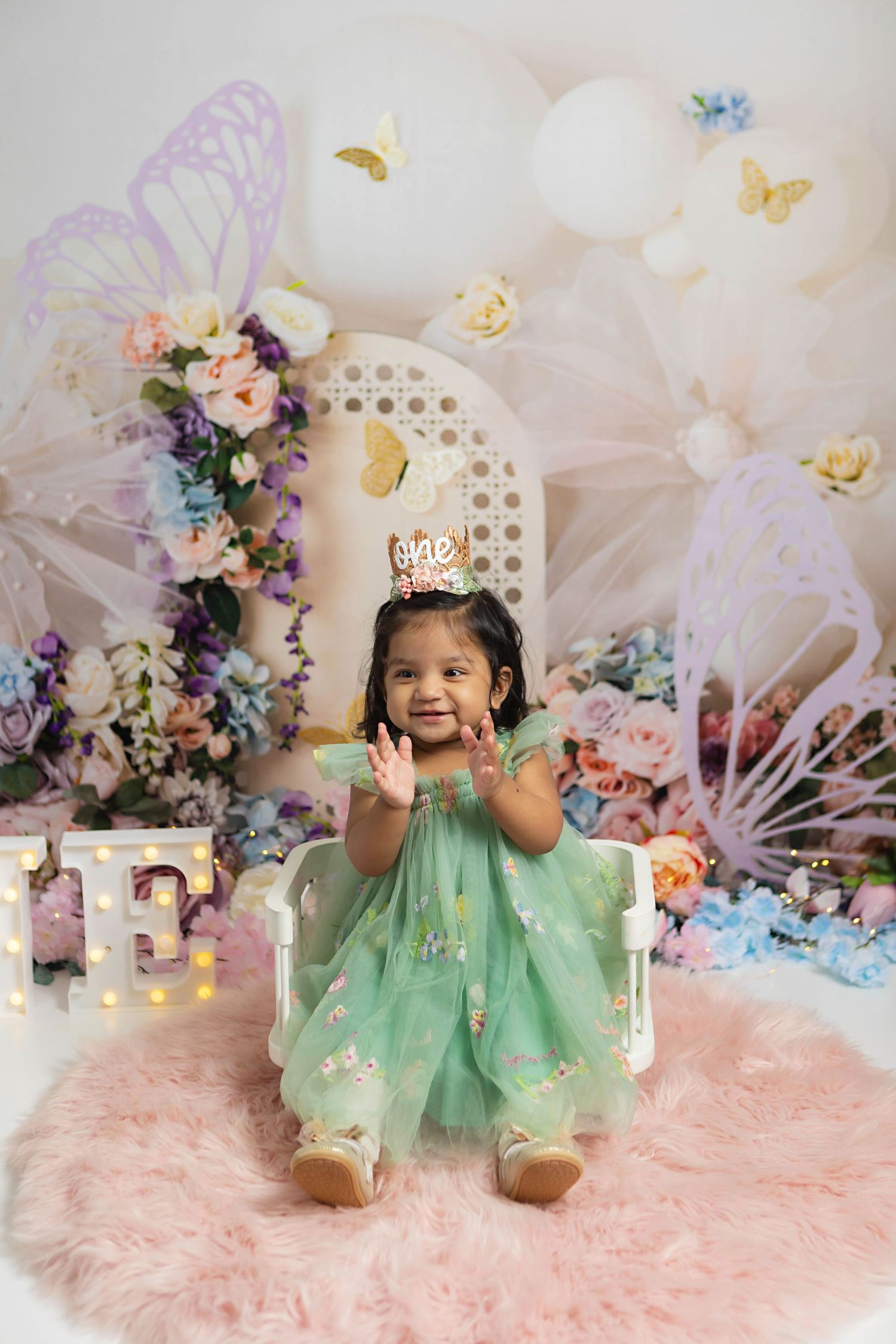 First birthday photos of a baby girl using a fairy themed set