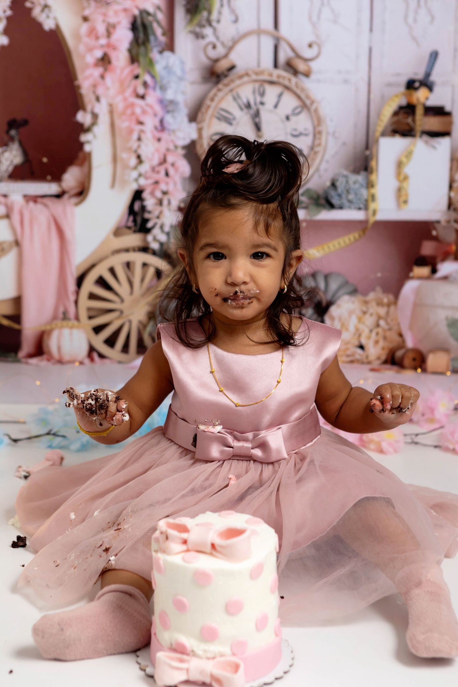 Princess themed first birthday session with baby girl and her polka dot cake