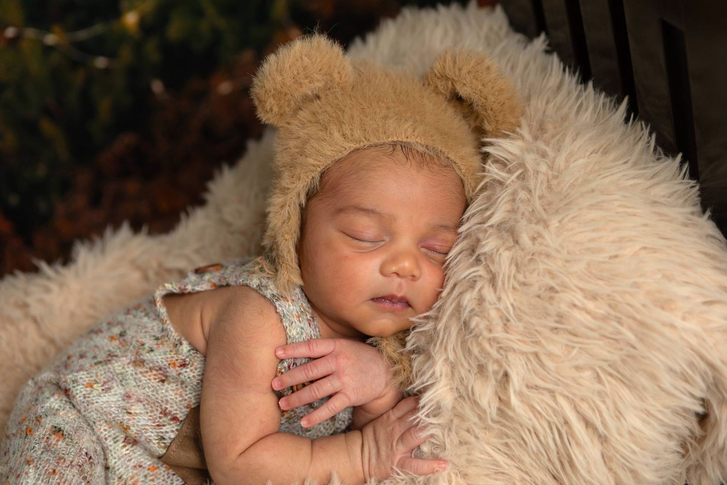 Newborn baby beautifully styled in studio props