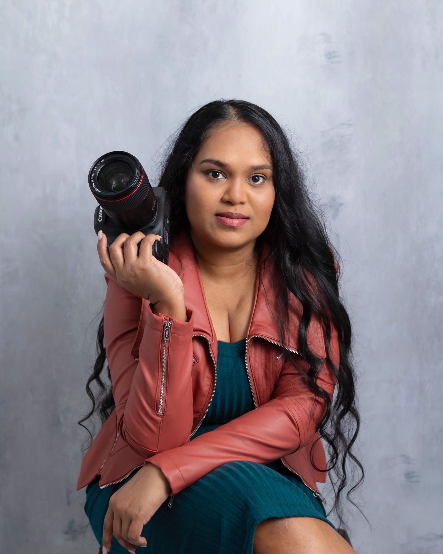 Photographer posing with camera in hand