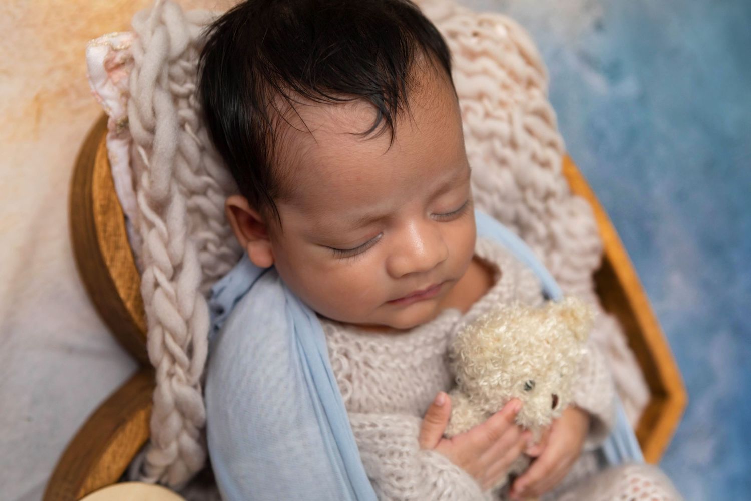 Newborn baby beautifully styled in studio props