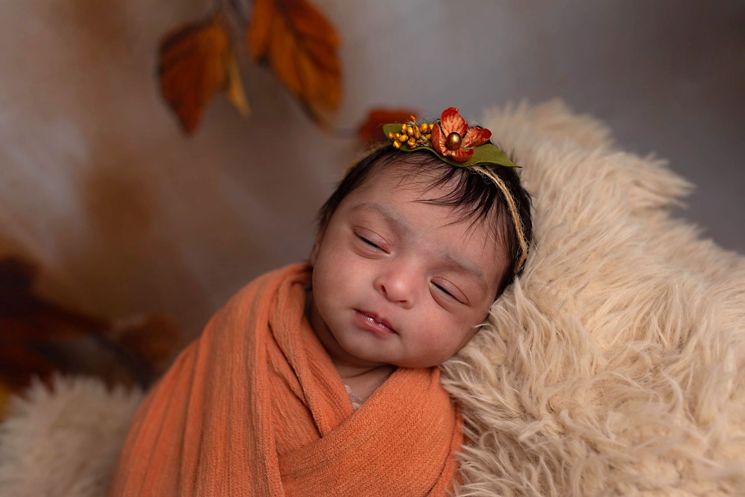 baby girl in orange wrap