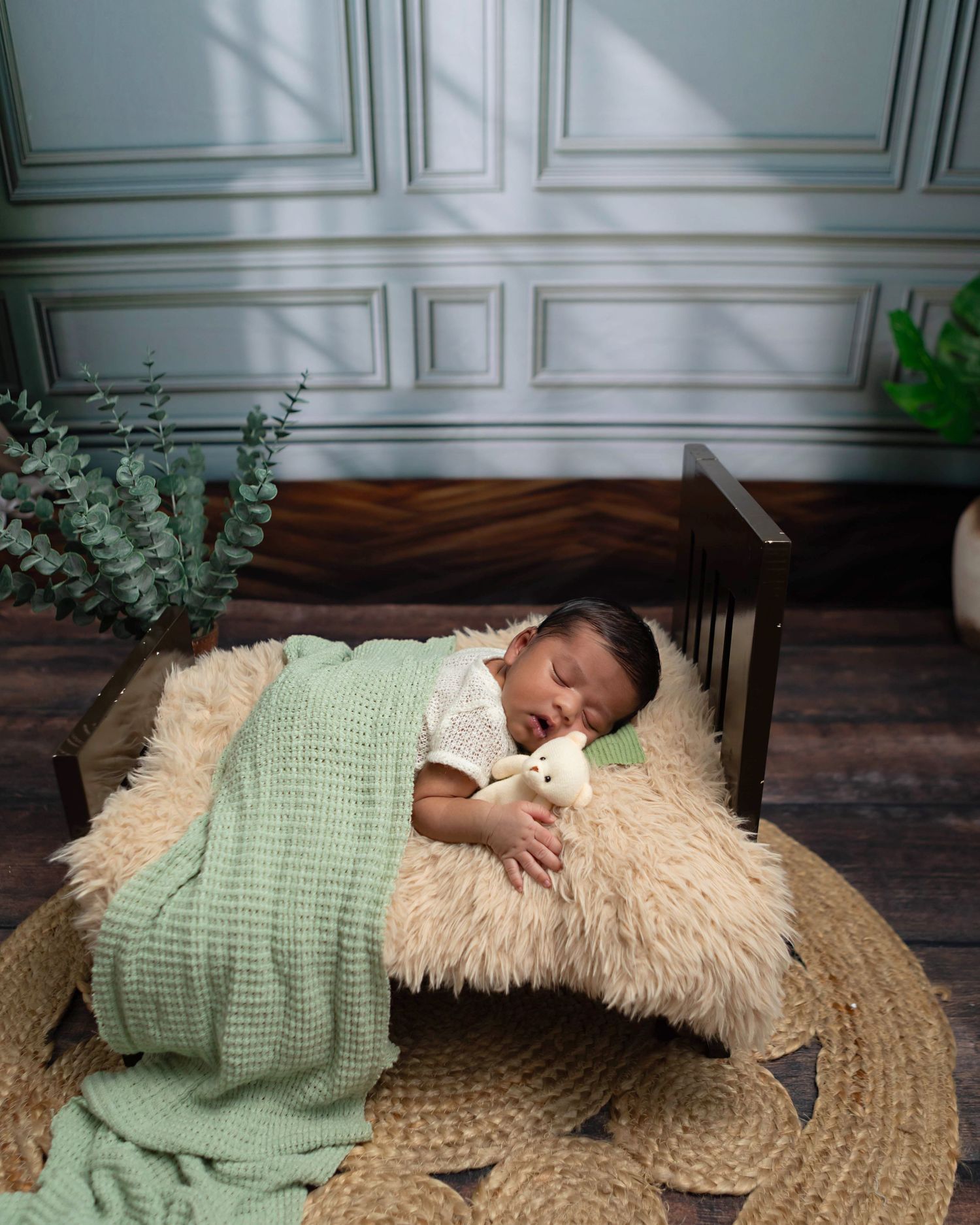 Newborn baby boy beautifully styled in studio props