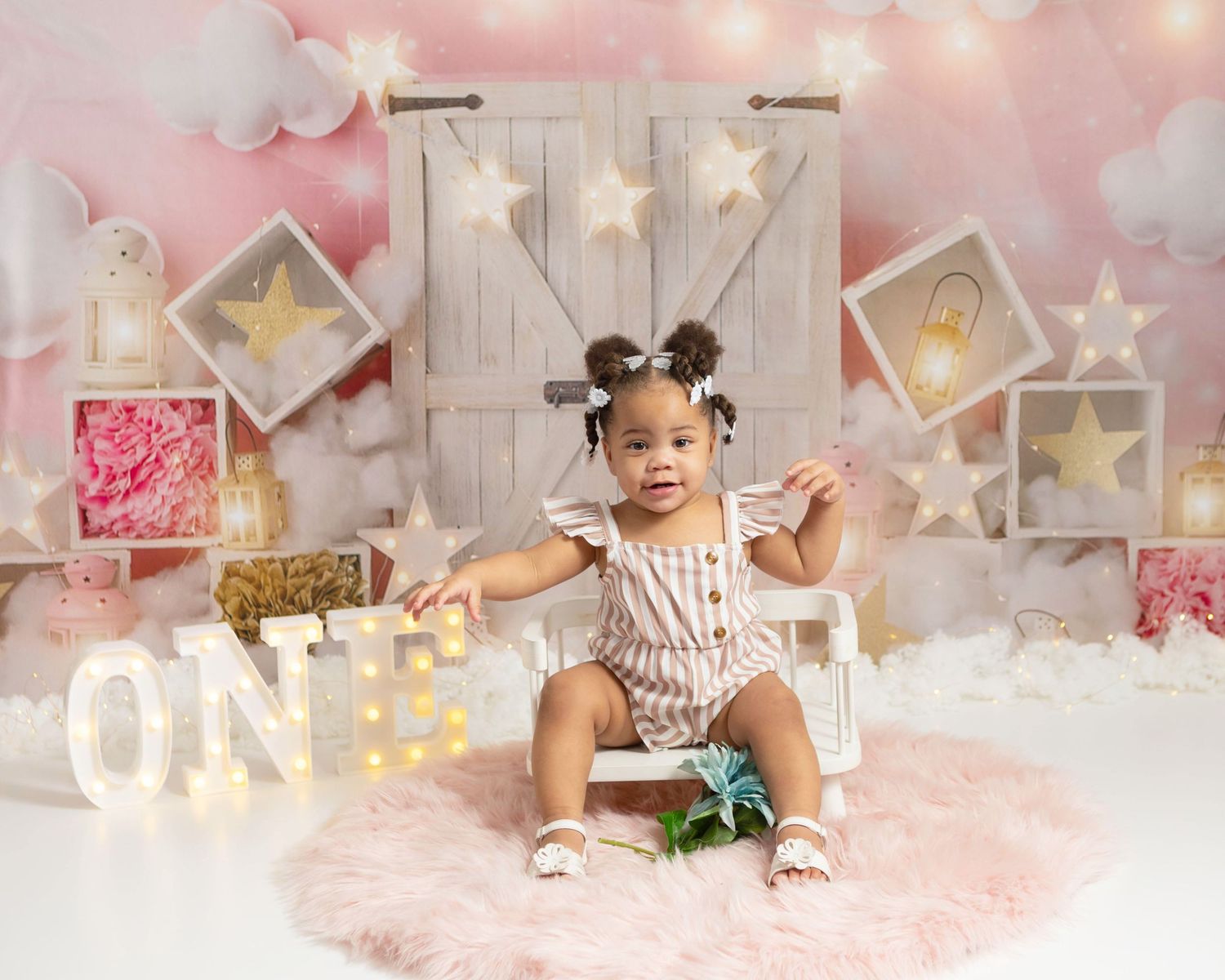 Baby girl sitting on a small white chair